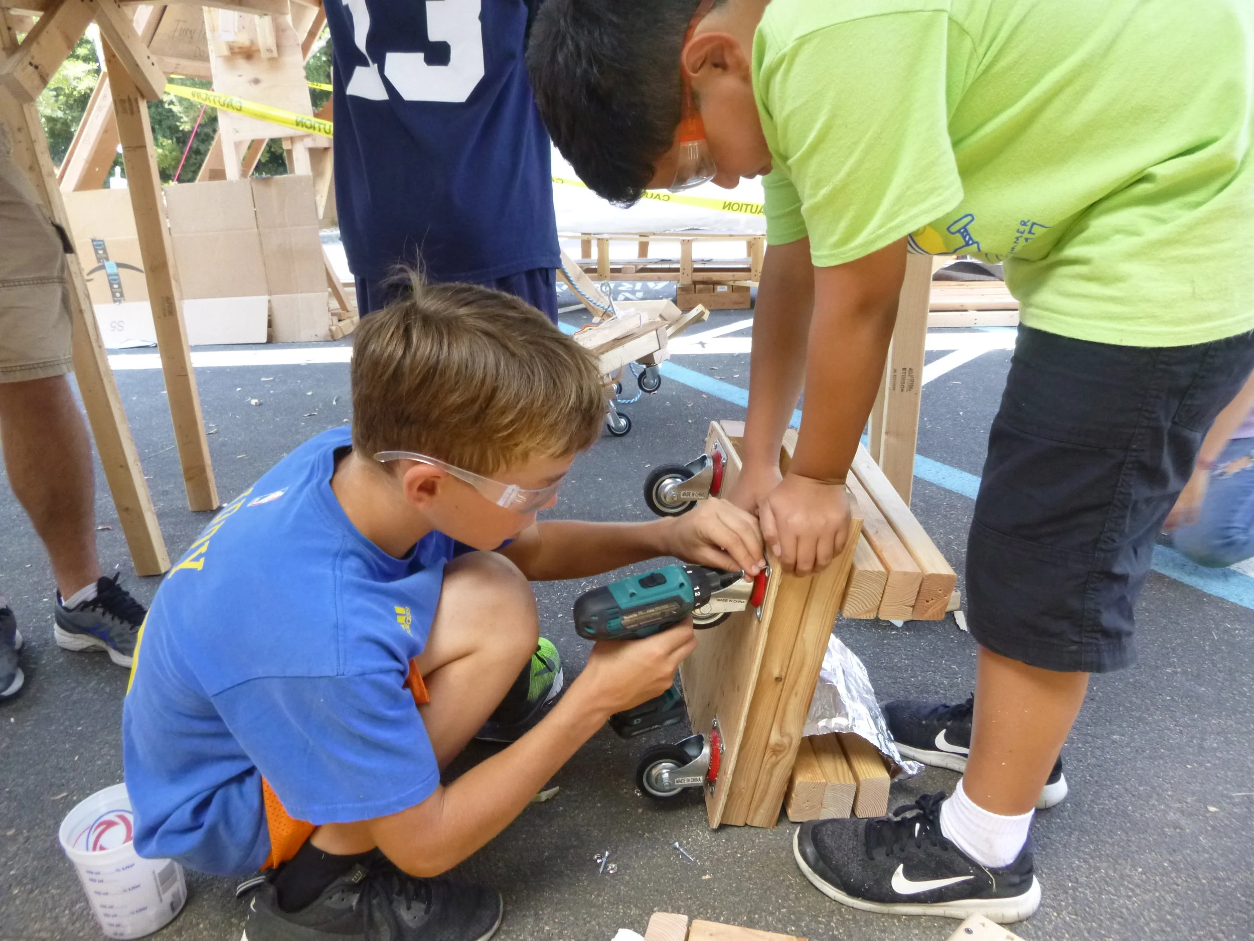 Jaden and Taelon adjusting the monorail wheels.