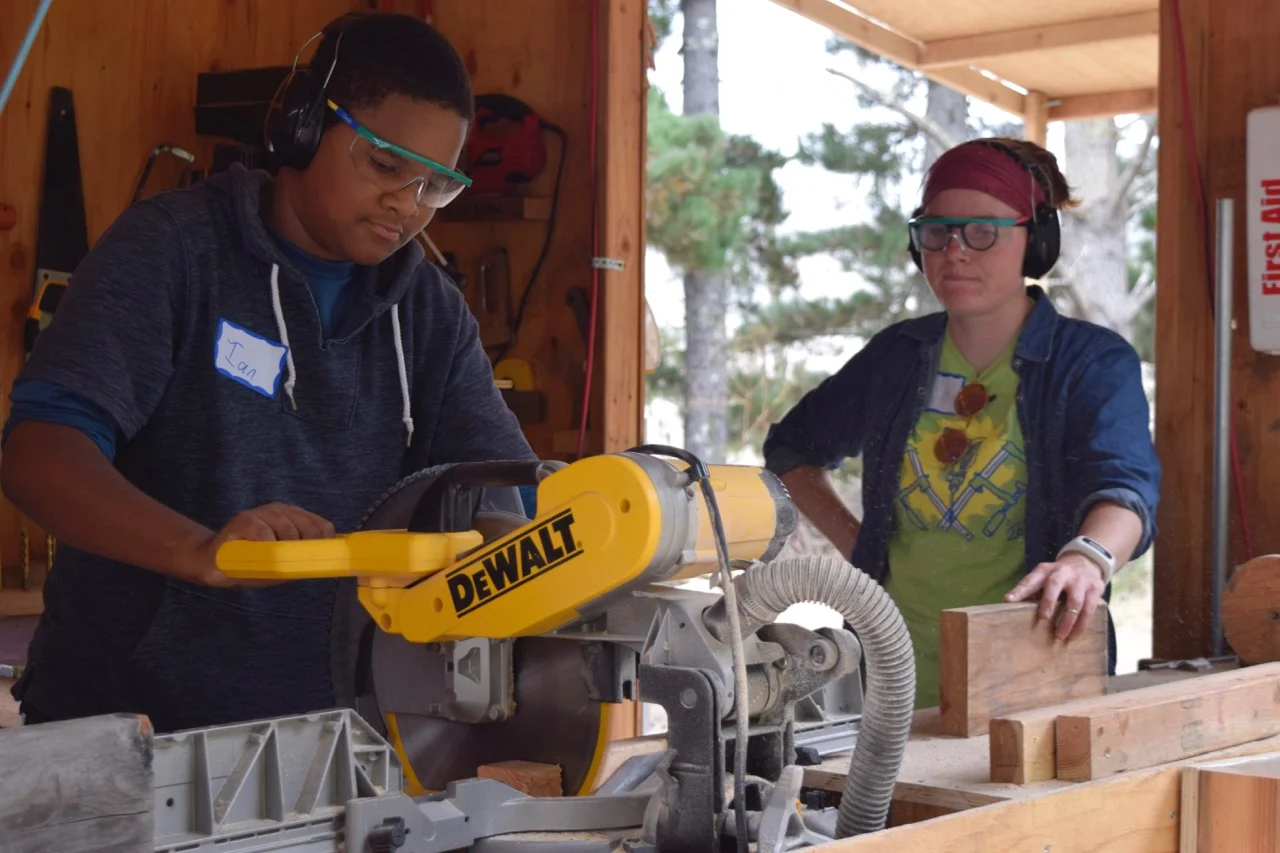 Ian is the first to try the chop saw.