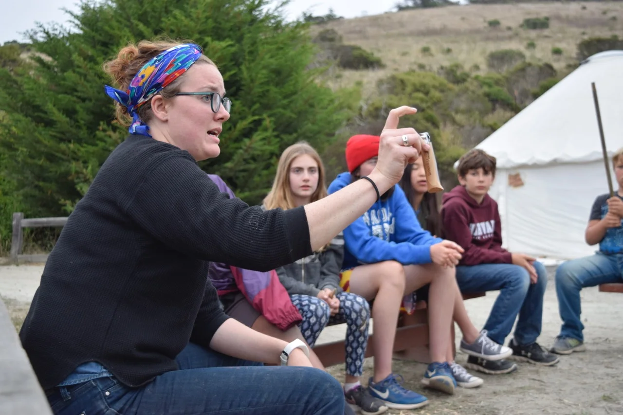 Kaitlyn presents how to use a knife safely to campers.