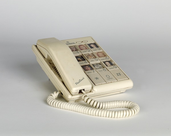    Touch phone with images of friends and family members. Circa 1970   