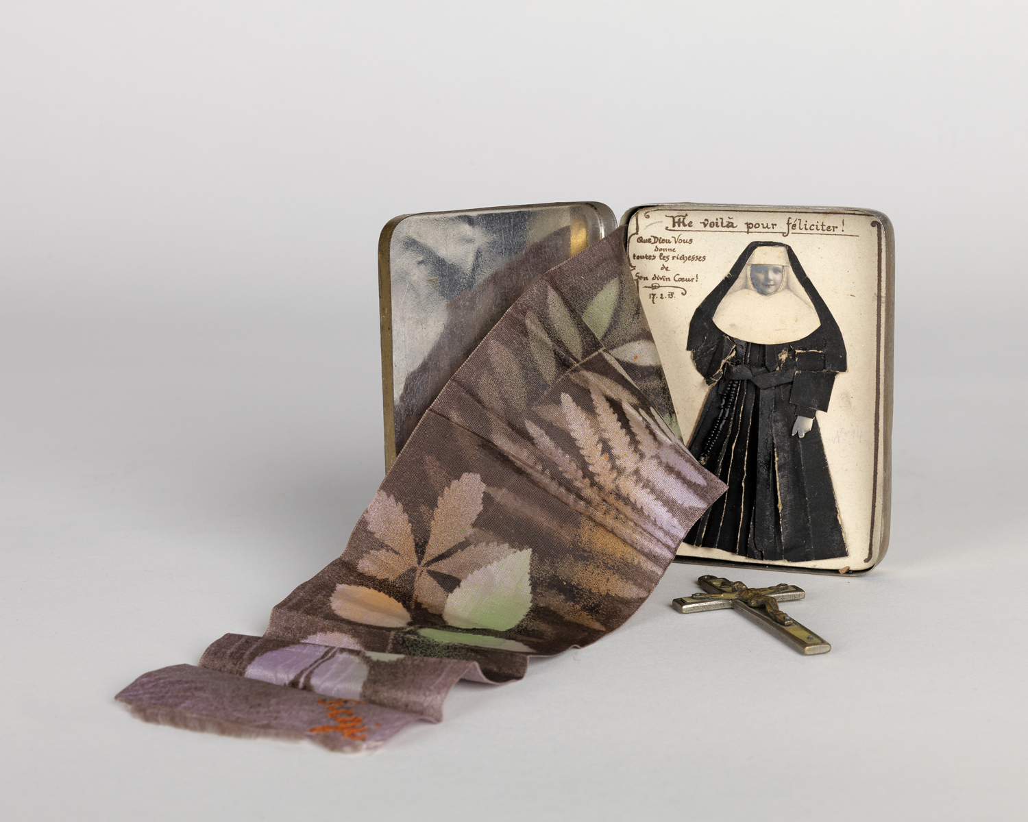    World War I-period curiosity with original photograph of a nun, cross,&nbsp; photogram and handwritten notations. Circa 1918   