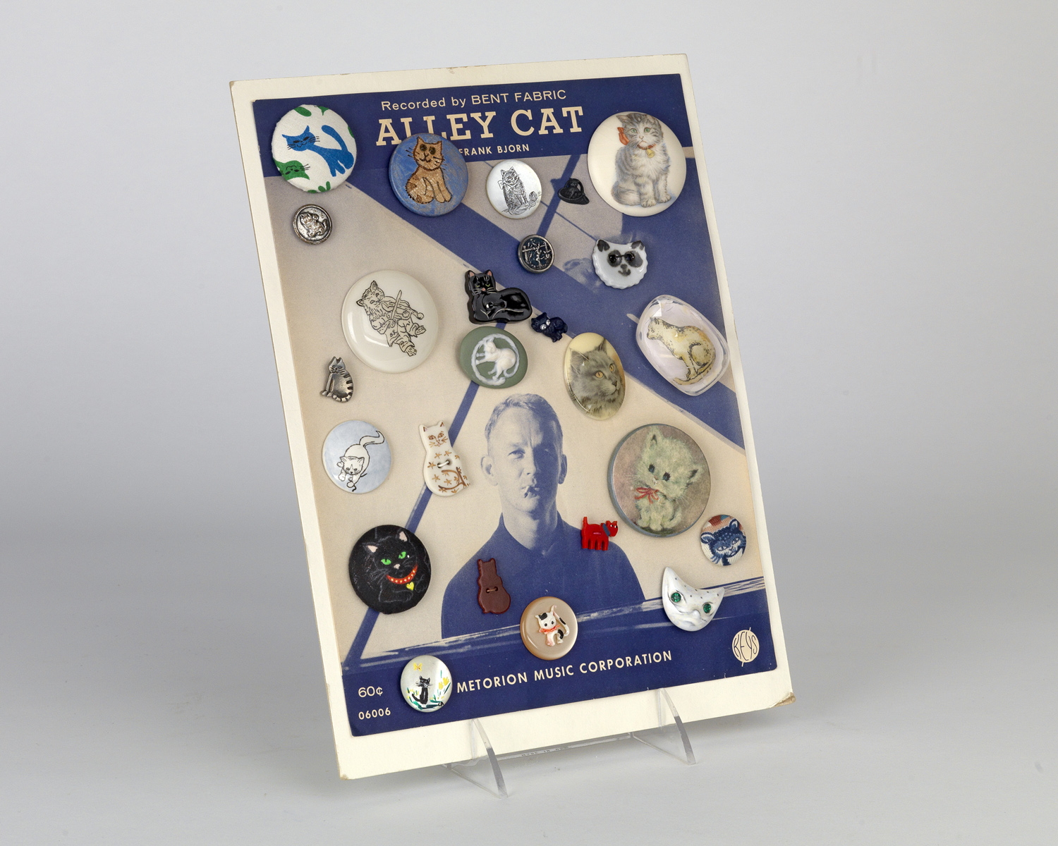    Buttons highlighted with images of cats set against the score of Alley Cat. Circa 1961   