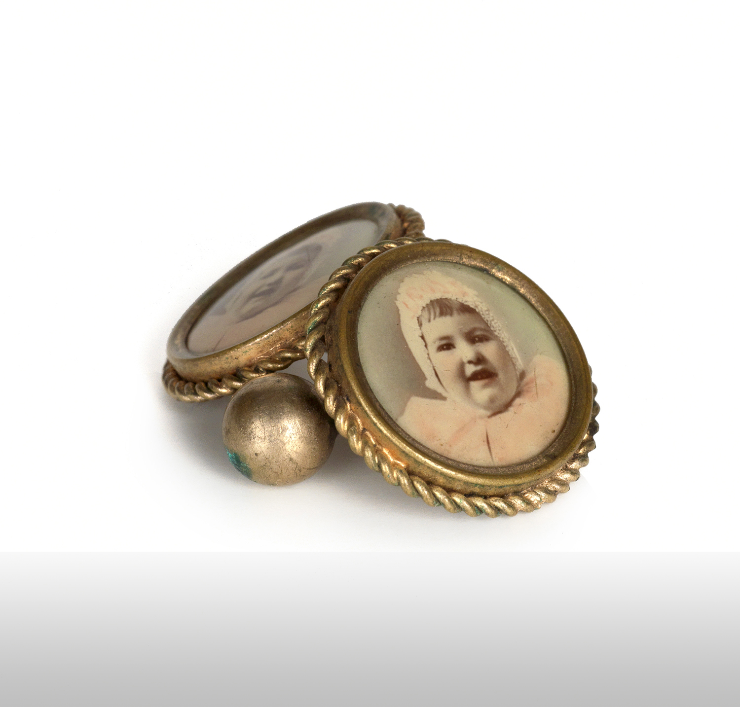    Cuff links with celluloid photographs of a baby. 1910s   