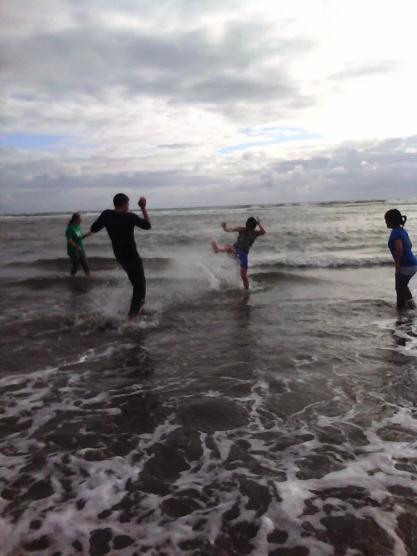 Teens "kickin' it" at the beach
