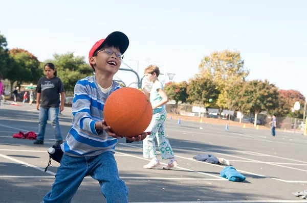 Boy plays Four square at a playworks recess.
