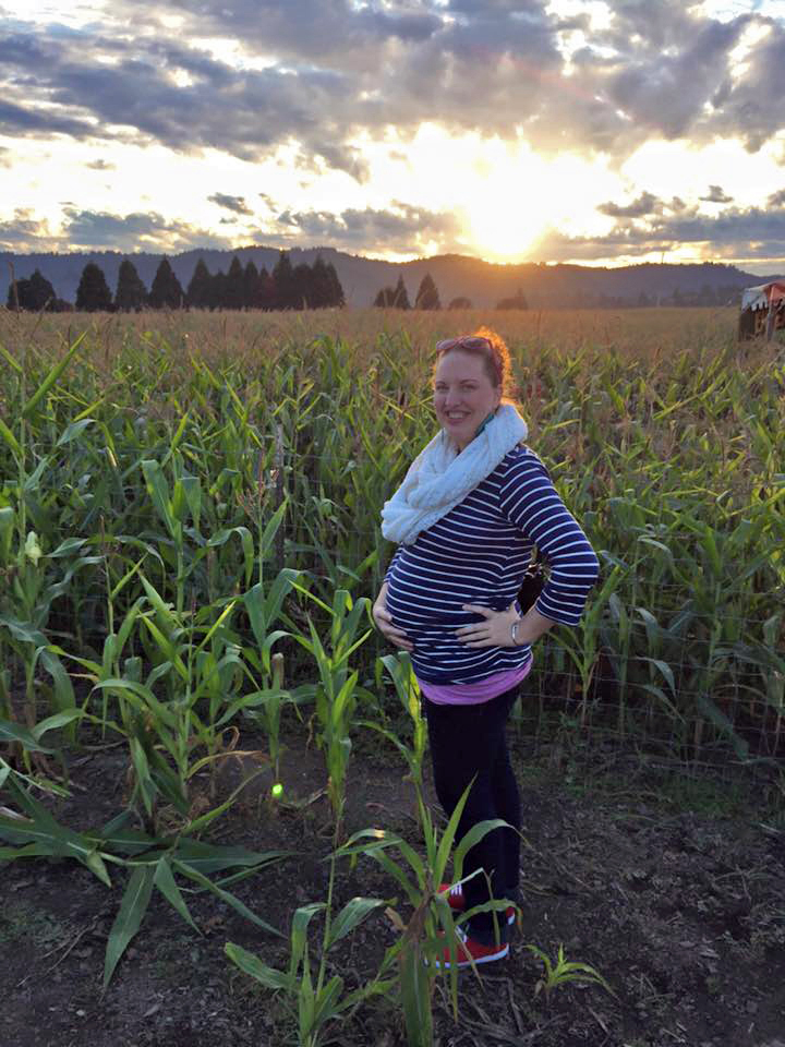 Stephenie standing in a field of corn. 