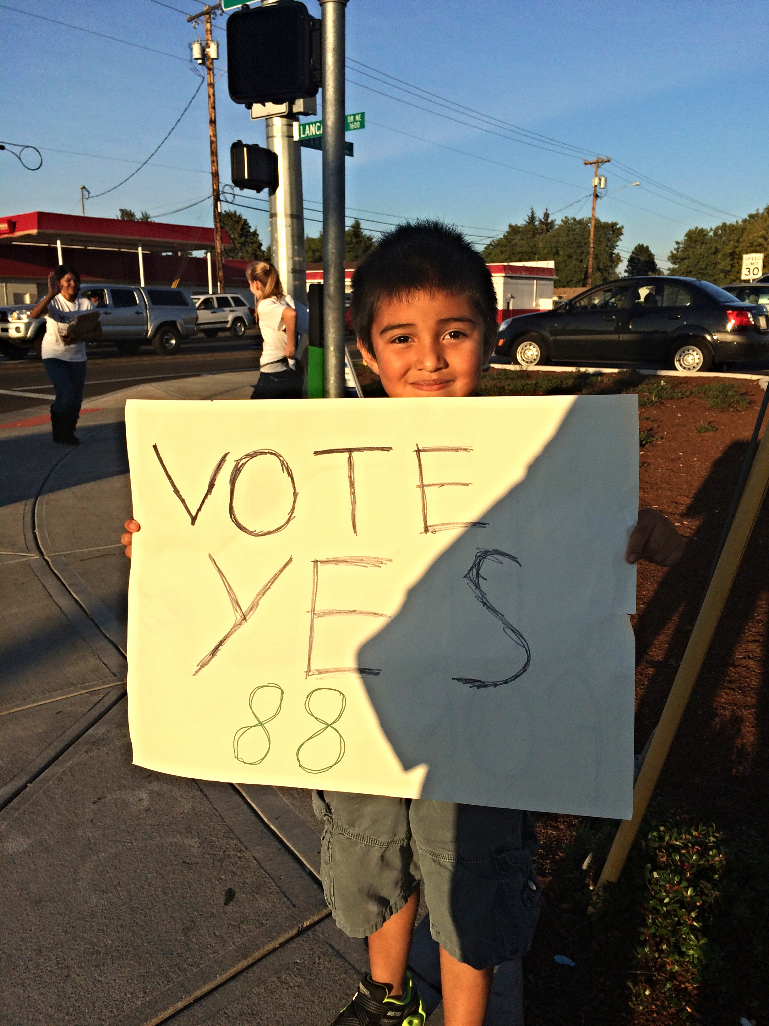 A little boy holding up a sign in support of Measure 88, which would have instituted Driver Cards for undocumented immigrants.