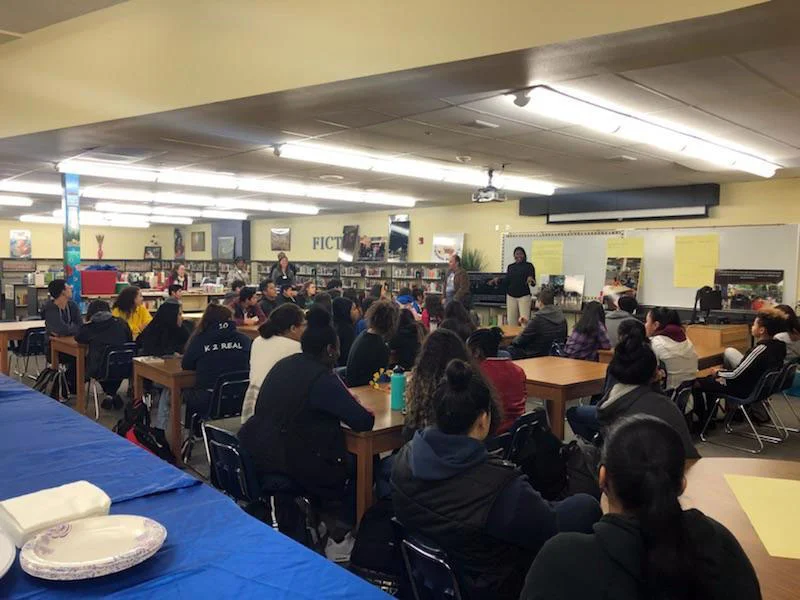 Ophelia Noble speaks to a library full of Kelso High School students.