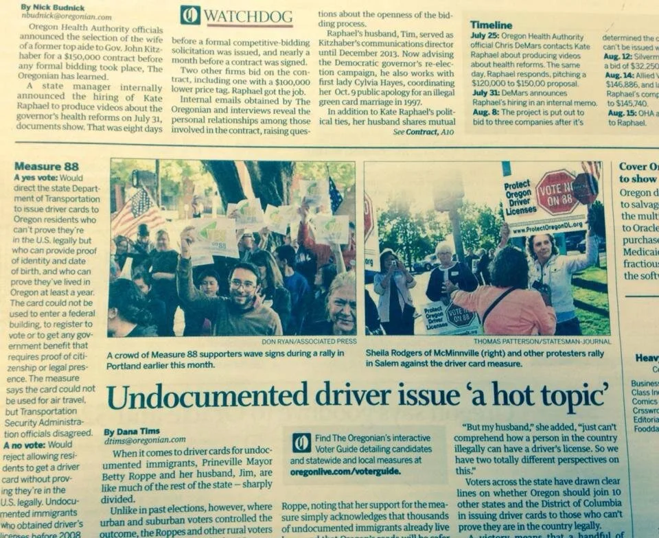 A photo of Eddie in the Oregonian , holding a sign at a Yes on Measure 88 rally.