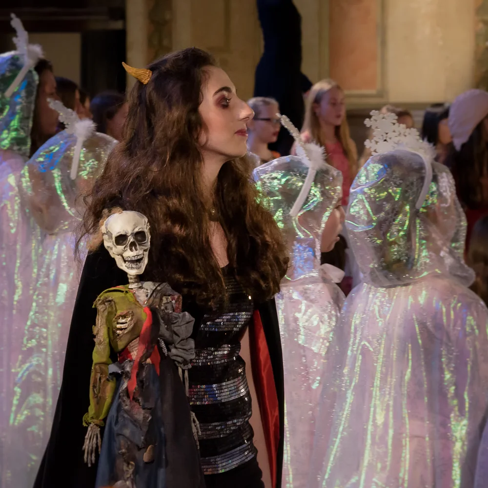 Caroline, Vireo's "mysterious twin" (Emma MacKenzie) appears in devilish garb, accompanied by her strange doll/totem.