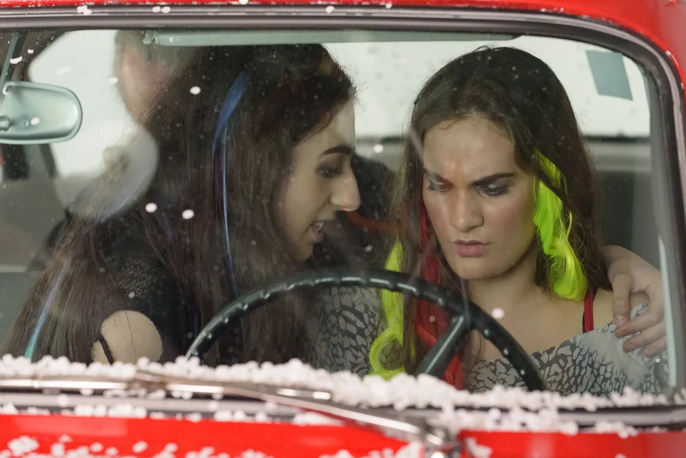 Caroline (Emma MacKenzie) and Vireo (Rowen Sabala) in the red Valiant.