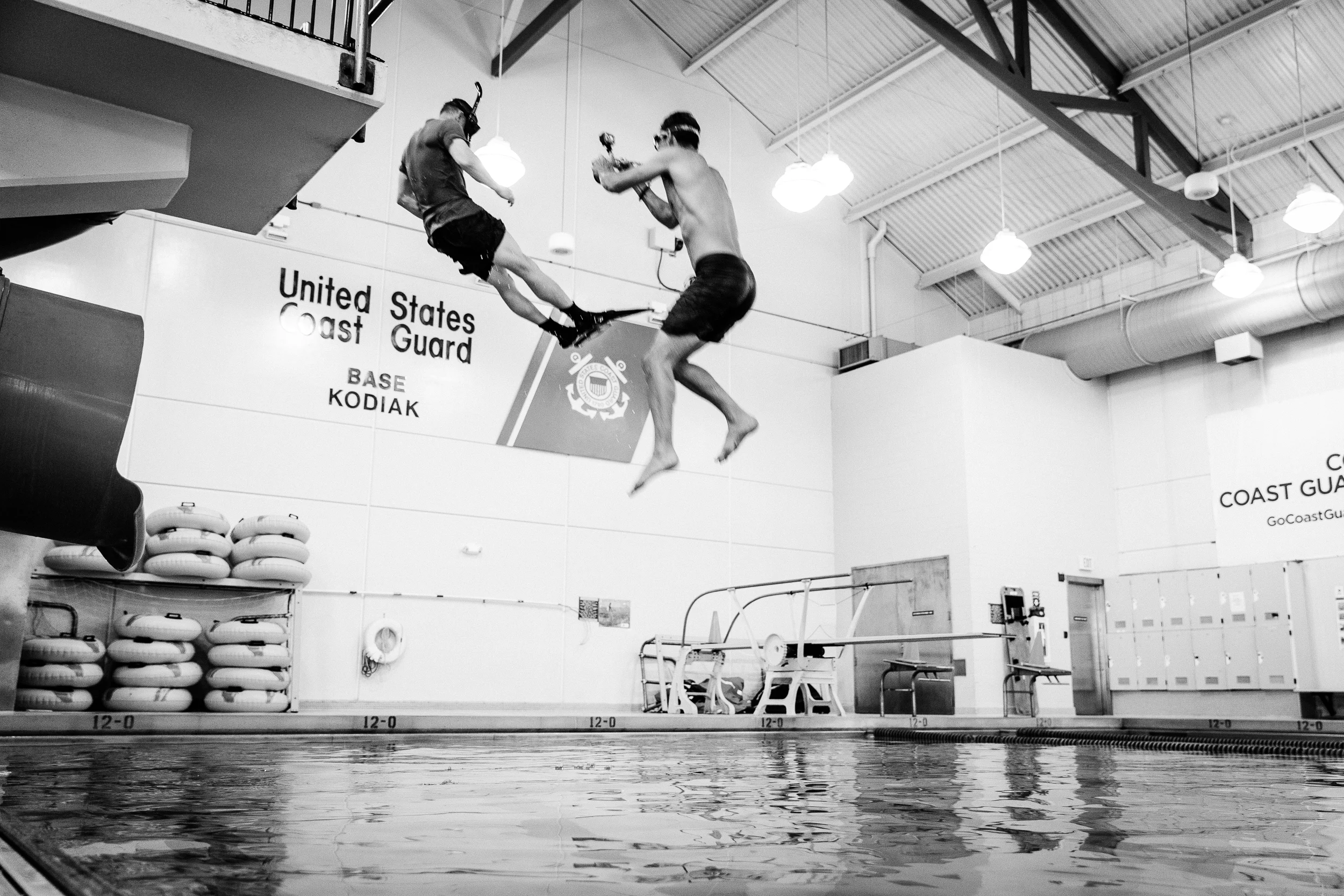 Justin Bastien diving in with a Rescue Swimmer in the USCG training facility. Kodiak Air Station, Alaska.