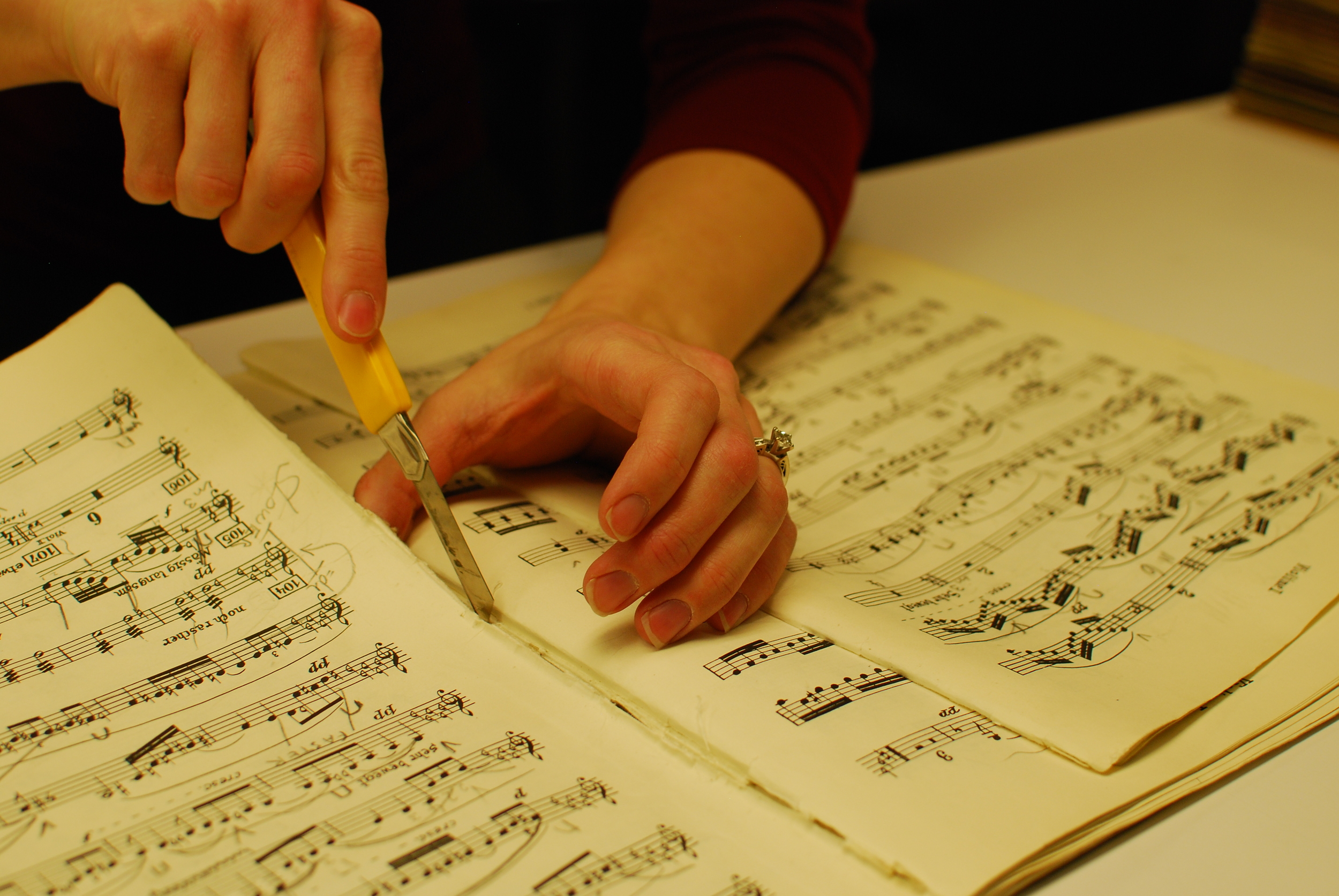Melissa Robason demonstrates a repair technique on a concertmaster part for Strauss' Arabella . 