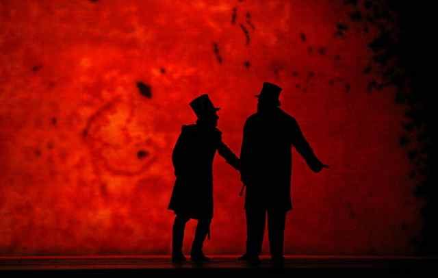 The Captain (left) consults with the Doctor (right) against a blood-red moon in Wozzeck. Photo by Ken Howard. © 2007 The Metropolitan Opera