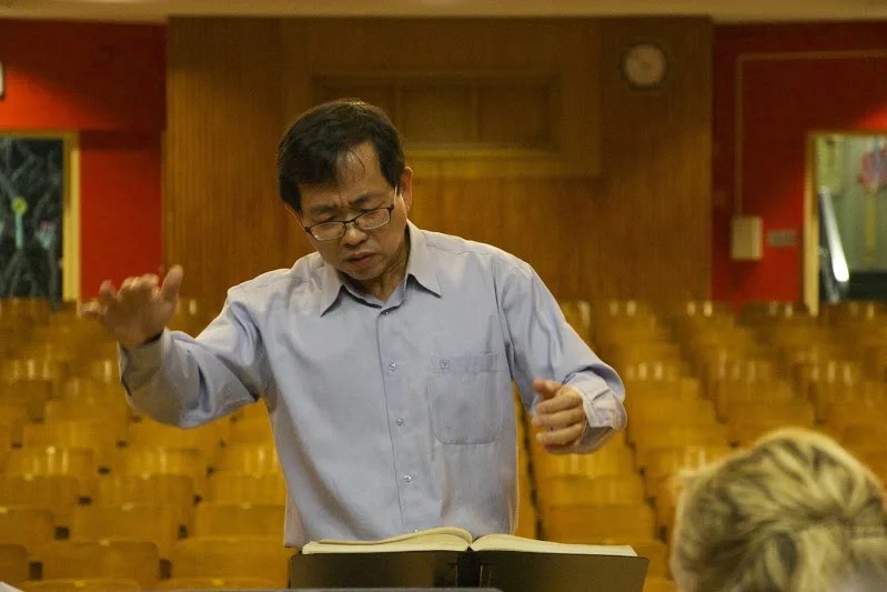 Violinist Ming Hsin bringing his talents to the conductor's podium (Photo by Rob Knopper)