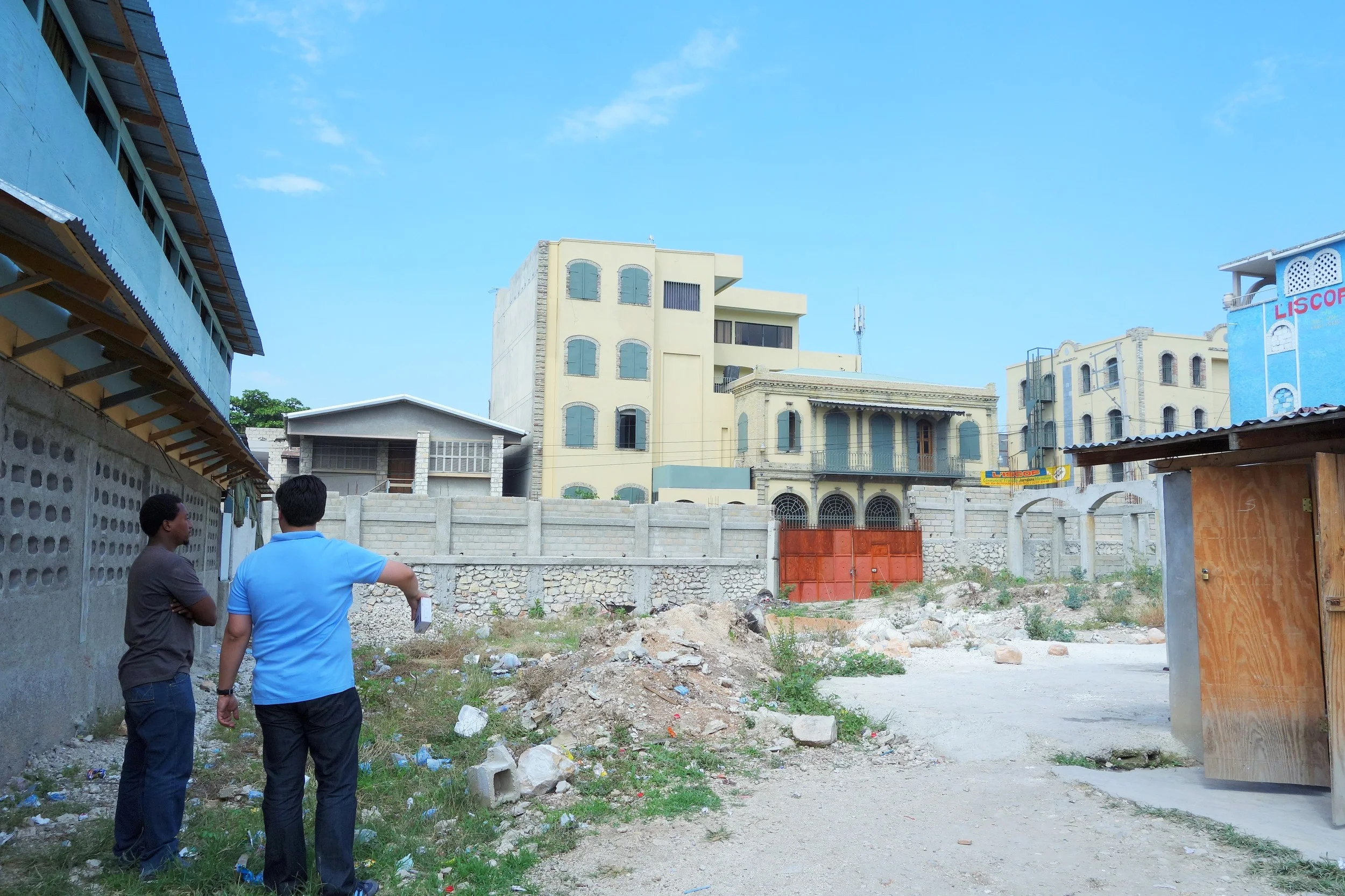 Signs of devastation in Haiti are everywhere. Here, MESDA founder Enrique Márquez visits one the of school's destroyed buildings with a student.