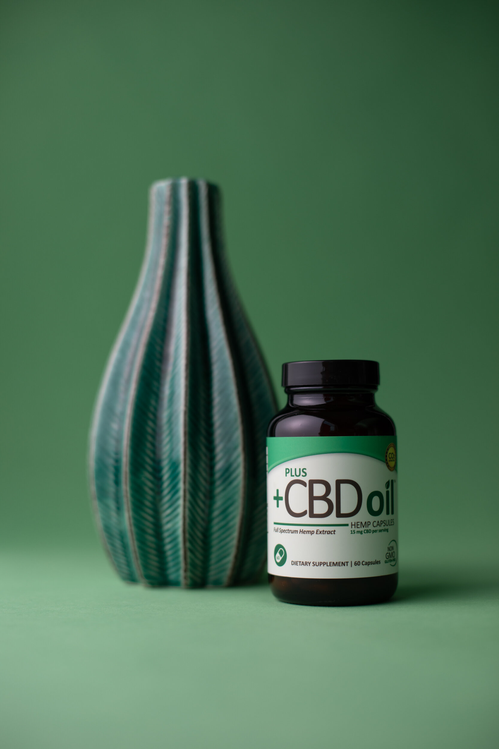 PlusCBD_Oil_Green_Capsules_Minimal_Green_Vase-2-9190x.jpg