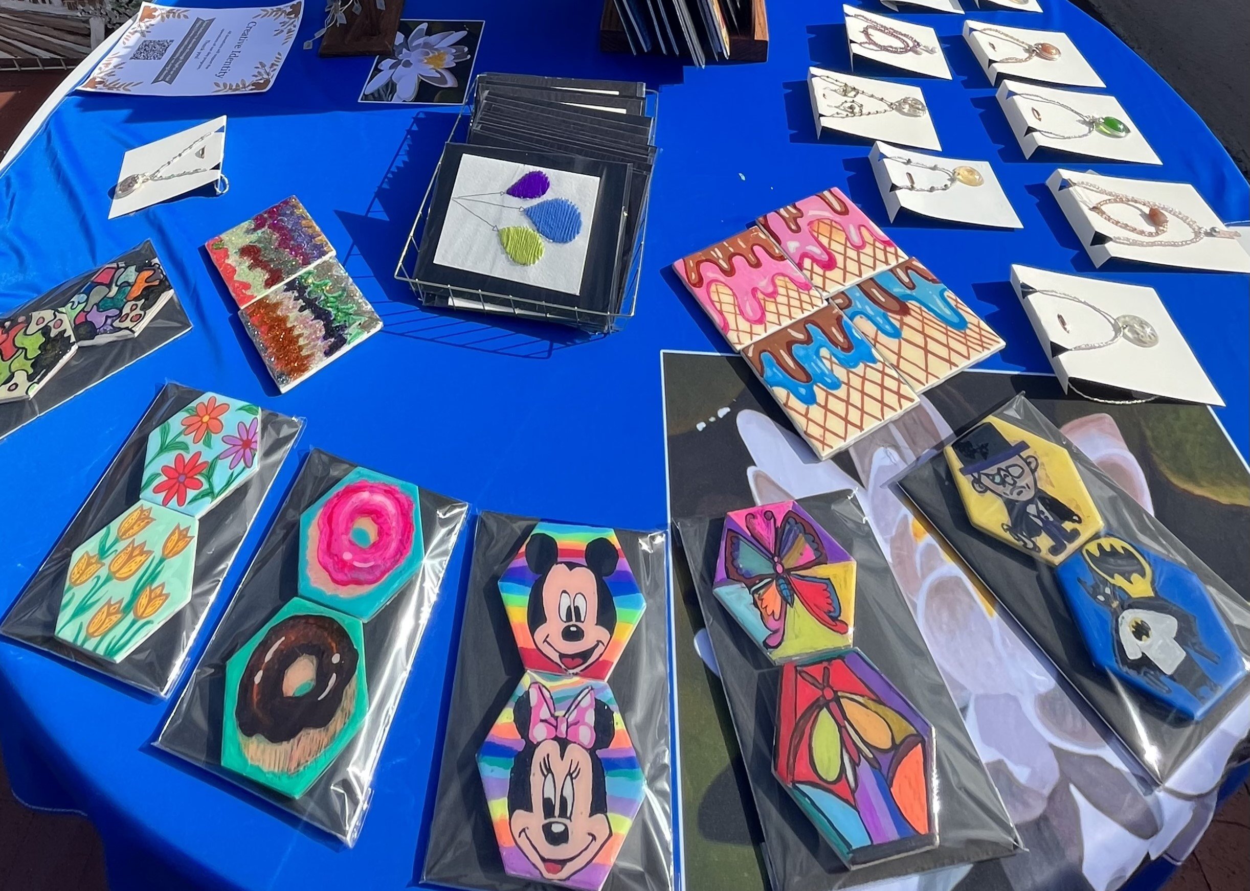  Boutique at the 2023 Laguna Beach Fall Recital and Art Exhibition with numerous paintings, coasters, magnets, jewelry, and more made by the Laguna Beach participants. 