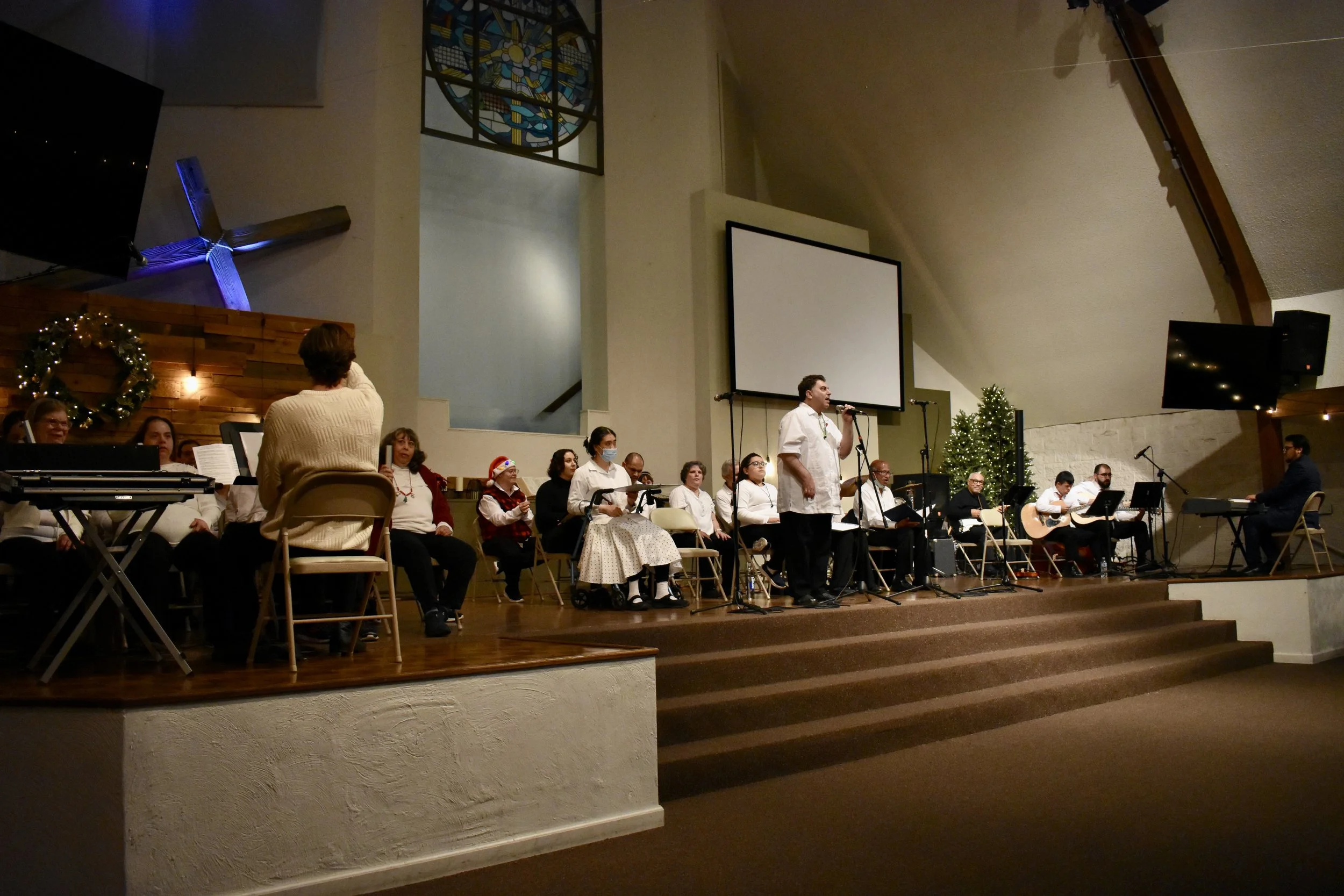  Creative Identity Anaheim participants singing, dancing, and playing instruments for their 27th Annual Winter Concert to an audience of attendees. 
