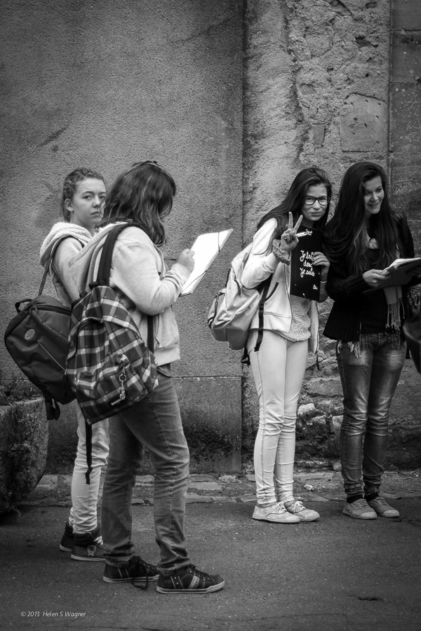 A young woman's peace / friendship gesture in Bayeux, France, invited me to keep my camera raised and make images of the students in the group.