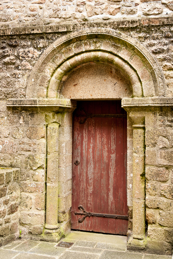 An old, weathered door at the Mont Saint-Michel Abbey.