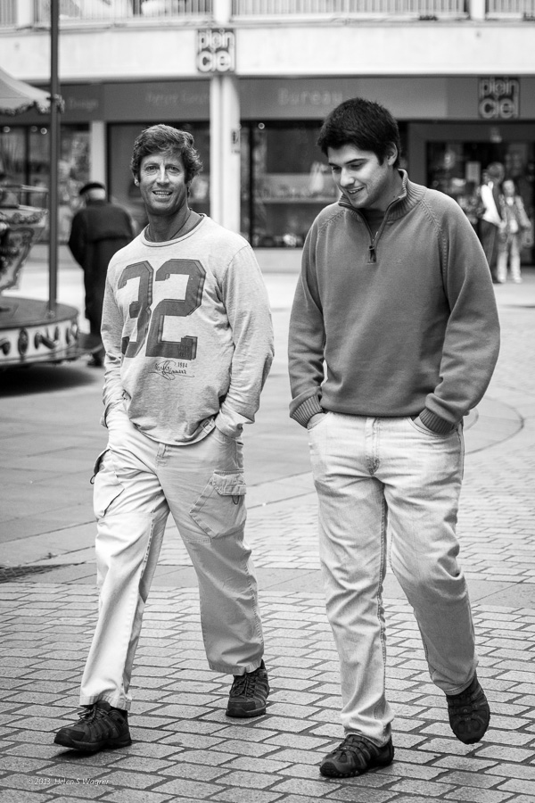 An early evening was a perfect time for two men to engage in conversation as they walked through the city.