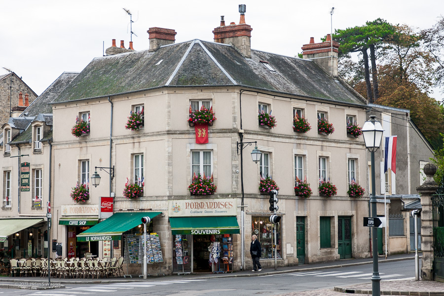 A corner café and market with window boxes adorned with brightly colored flowers was typical of scenes in Bayeux.