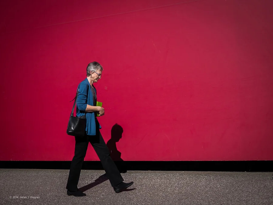 A red wall in front of the Guthrie Theater provided a great backdrop to make an image of a woman passing by.