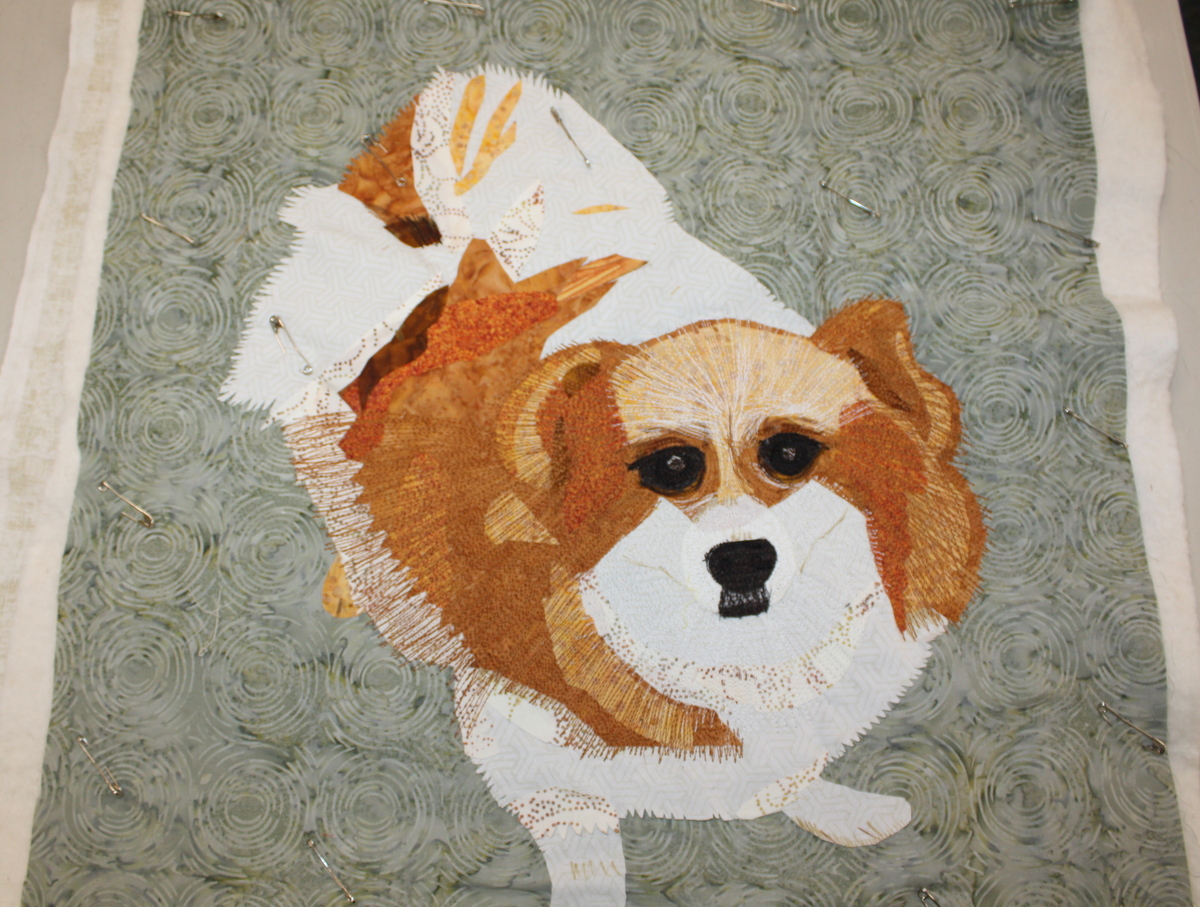 This sweet dog was stitched down with plenty of thread play bringing out his fluffy personality.