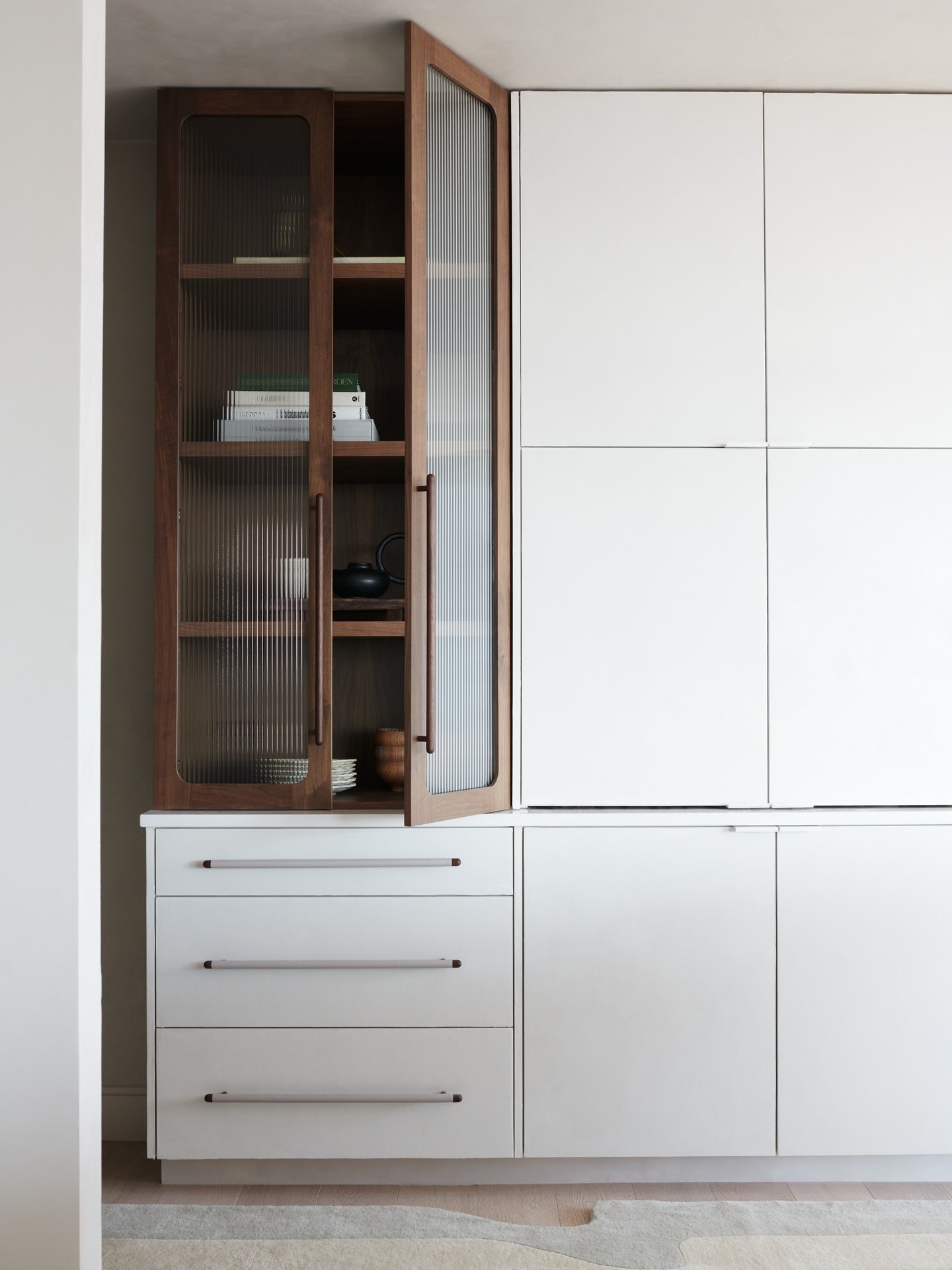 This feature walnut curio cabinet brought to life by @mule_studio ✨