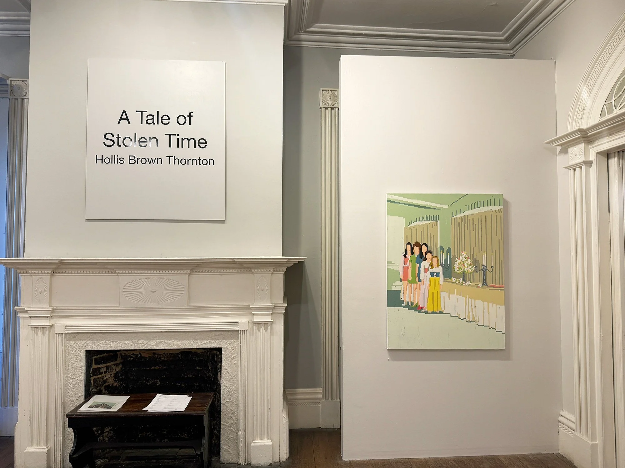 Image of an art exhibition titled "A Tale of Stolen Time" by Hollis Brown Thornton, featuring a pixelated painting of people at a gathering indoors on a white wall, with a fireplace and mantel to the left.