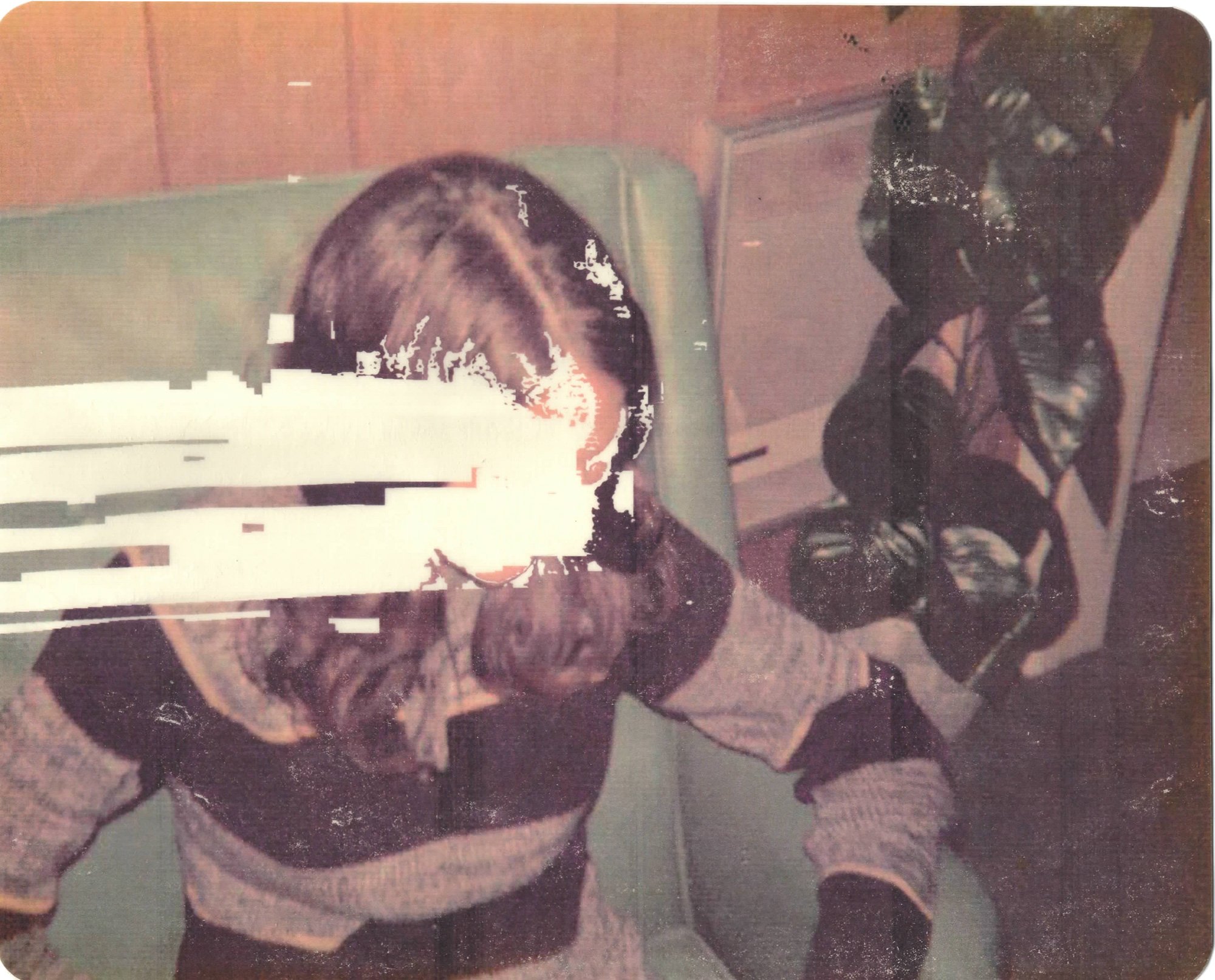Hollis Brown Thornton pigment transfer of an erased child in a striped sweater, with horizontal white bands extending across the face in a vintage interior.