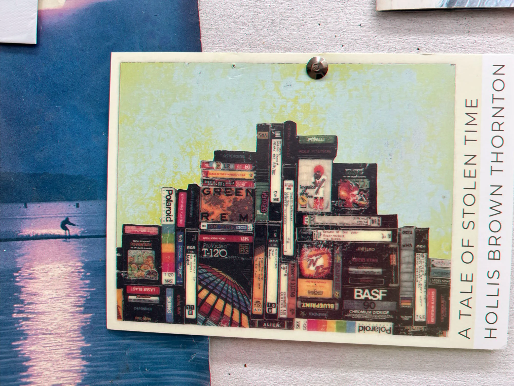 A collage of various products including books, VHS tapes, and electronic items arranged to mimic a city skyline, with the text 'A TALE OF STOLEEN TIME HOLLIS BROWNS THORNTON' on the right side.