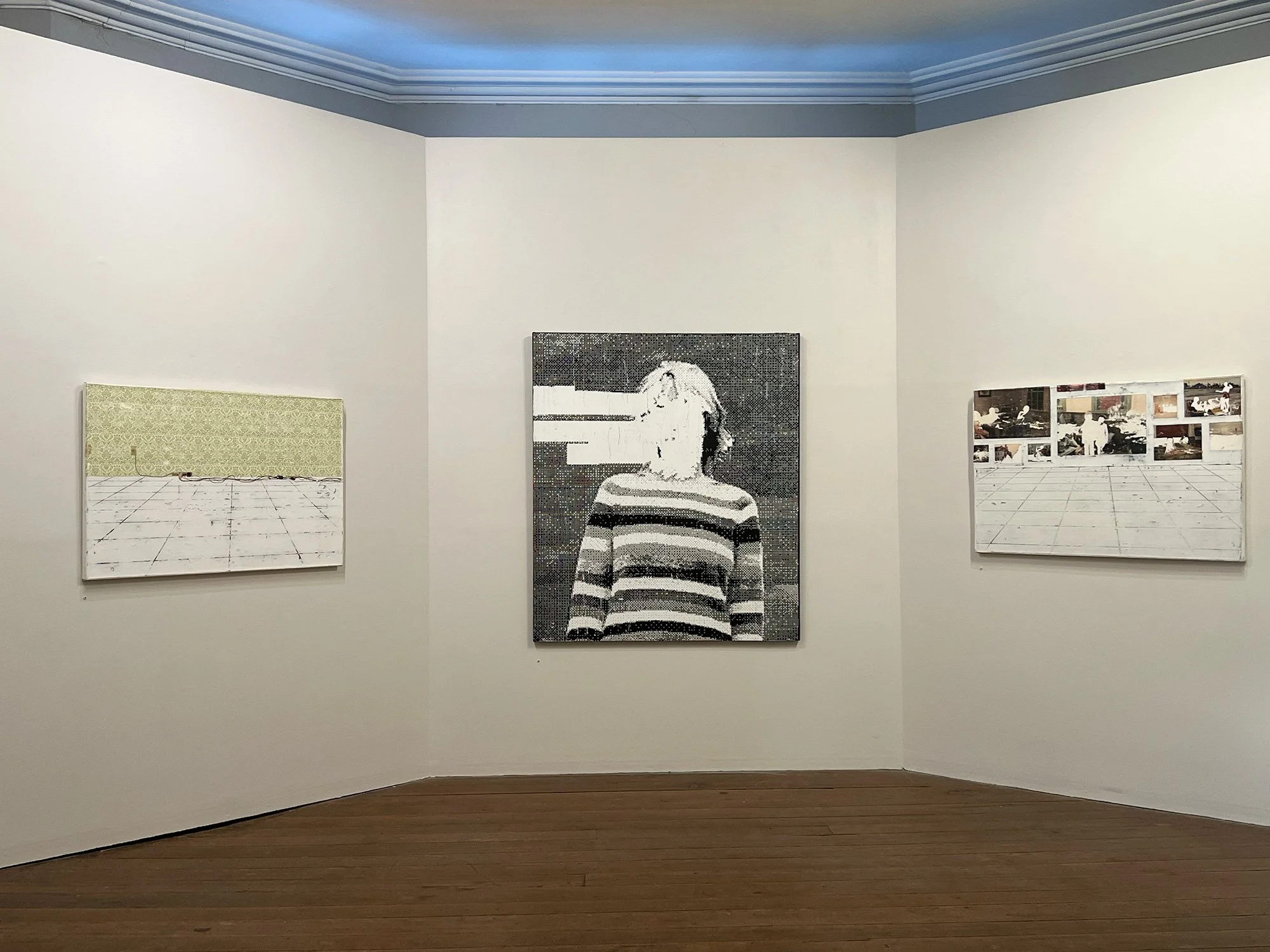 Gallery wall with three artworks: two paintings of interior spaces on either side and a pixelated portrait of a woman in a striped shirt in the center.