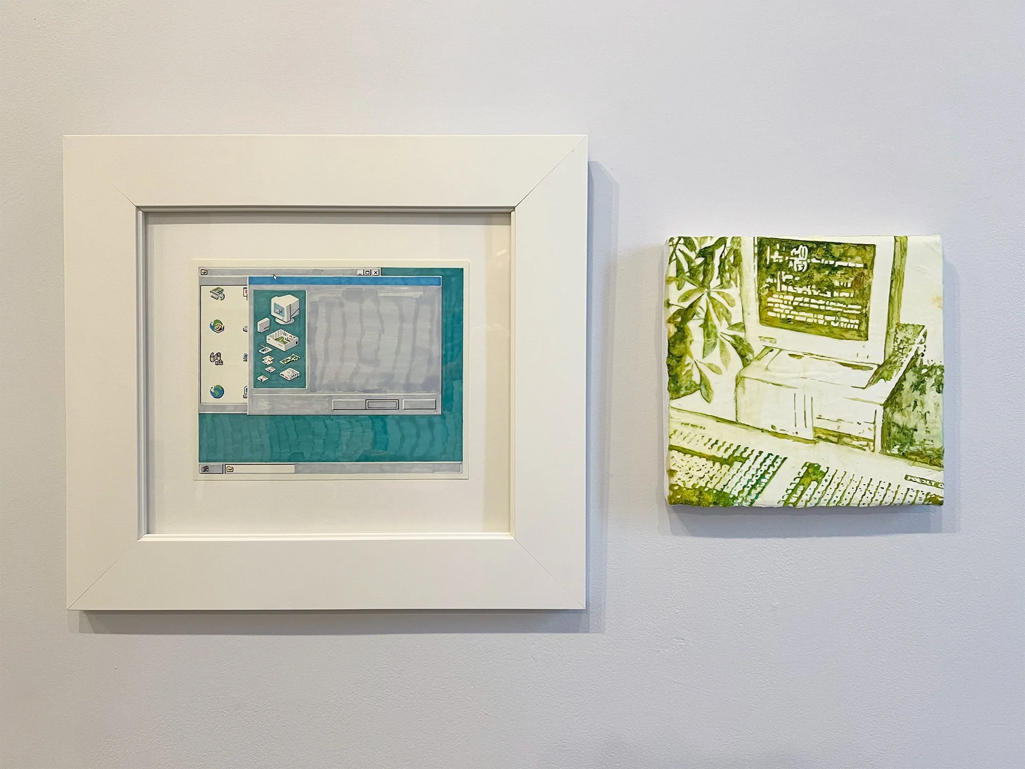 An art display featuring a framed digital pixel art piece and a small canvas painting, both mounted on a white wall.