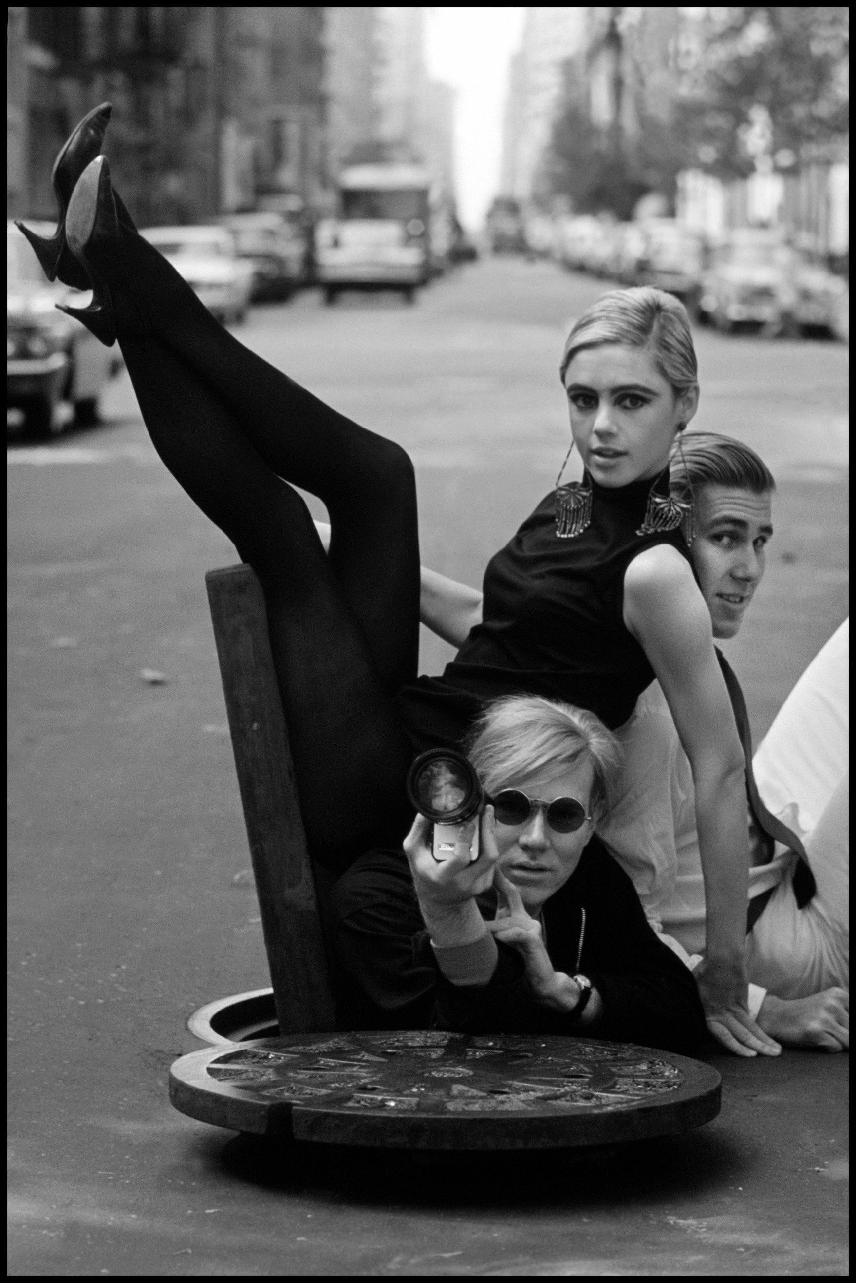  Burt Glinn   (1925-2008) Andy Warhol with Edie Sedgwick and Chuck Wein, New York City, 1965   Silver gelatin print  Signed in ink and initialed in pencil with photographer's fingerprint on verso   Provenance: Peter Fetterman Gallery  Image: 24 x 20 