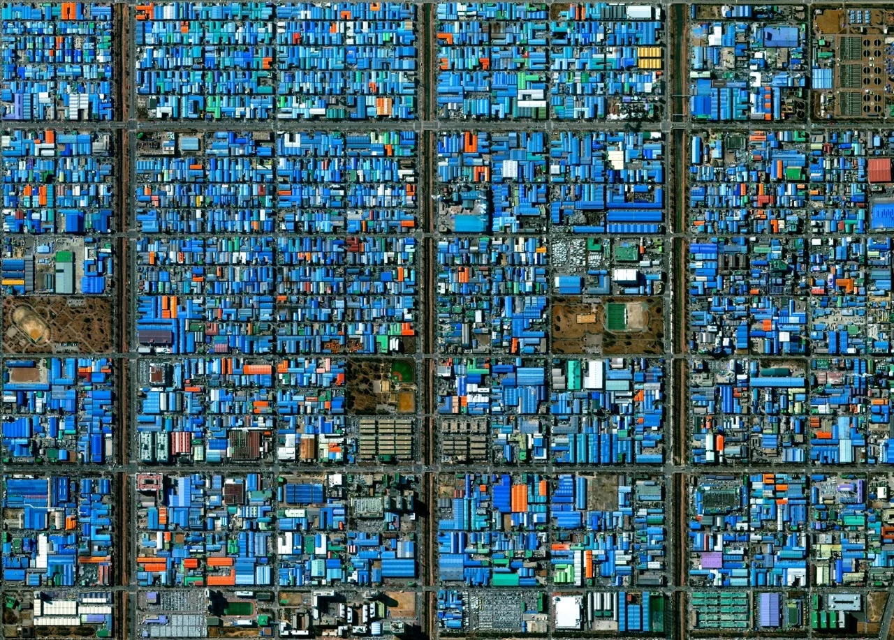 4/30/2015 Jeongwang-dong Ansan, South Korea 37.336147372°, 126.718586767° Jeongwang-dong is an industrial sector in the city of Ansan, South Korea. The Korean government intensively drove a plan to develop the modern city, particularly in this area, with an emphasis on manufacturing. The striking blue color that you see here results from the use of aluminum roofing, which is used for its low cost and longevity.
