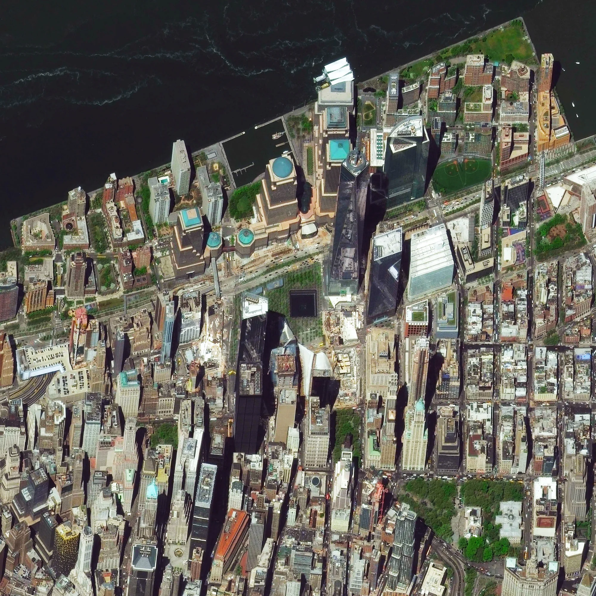 9/11/2015 One World Trade Center New York, New York, USA 40.7129465, -74.0117528 Today marks the 14th anniversary of the September 11th attacks in the United States. At the center of this Overview, we can see One World Trade Center and the North Pool of the 9/11 Memorial in downtown Manhattan, New York City.