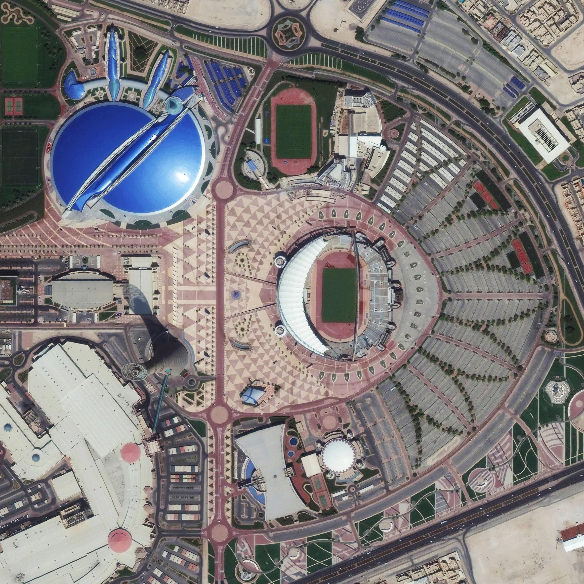 10/21/2015 Khalifa International Stadium Doha, Qatar 25°15′49.19″N 51°26′53.08″E Khalifa International Stadium is a massive sports complex in Doha, Qatar. The facility is currently undergoing a massive renovation and expansion in advance of the 2022 World Cup, which will be hosted by the Qataris. The blue structure adjacent to the stadium is Aspire Academy, a youth sports school. 