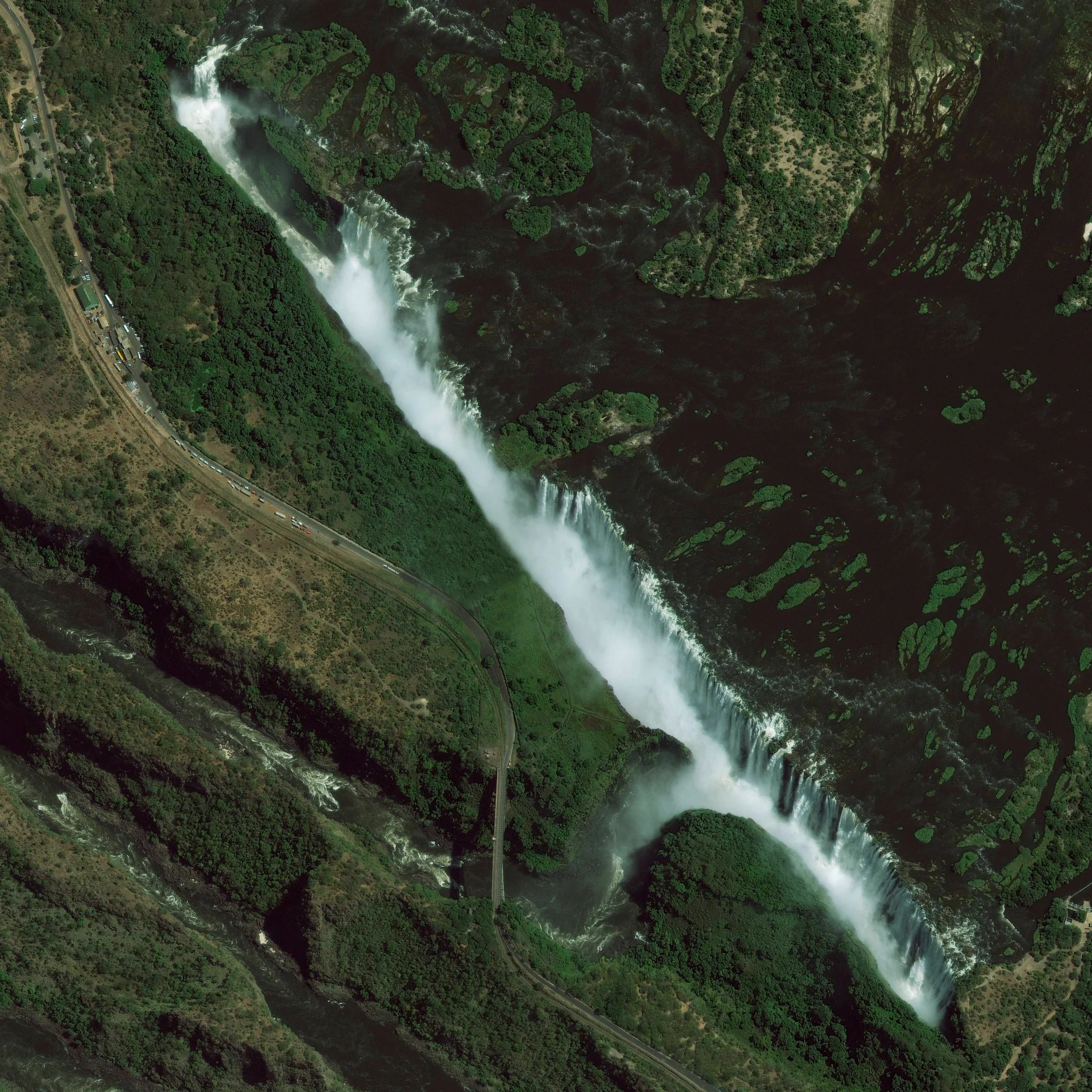1/4/2015 Victoria Falls Zambia / Zimbabwe 17°55′28″S 25°51′24″E Victoria Falls is a waterfall located on the Zambezi River at the border of Zambia and Zimbabwe. While it is neither the highest nor the widest waterfall in the world, it is classified as the largest with a width of 1,708 meters (5,604 ft) and height of 108 meters (354 ft). Accordingly the falls contains the world's largest sheet of falling water with a flow of approximately 1088 cubic meters per second.