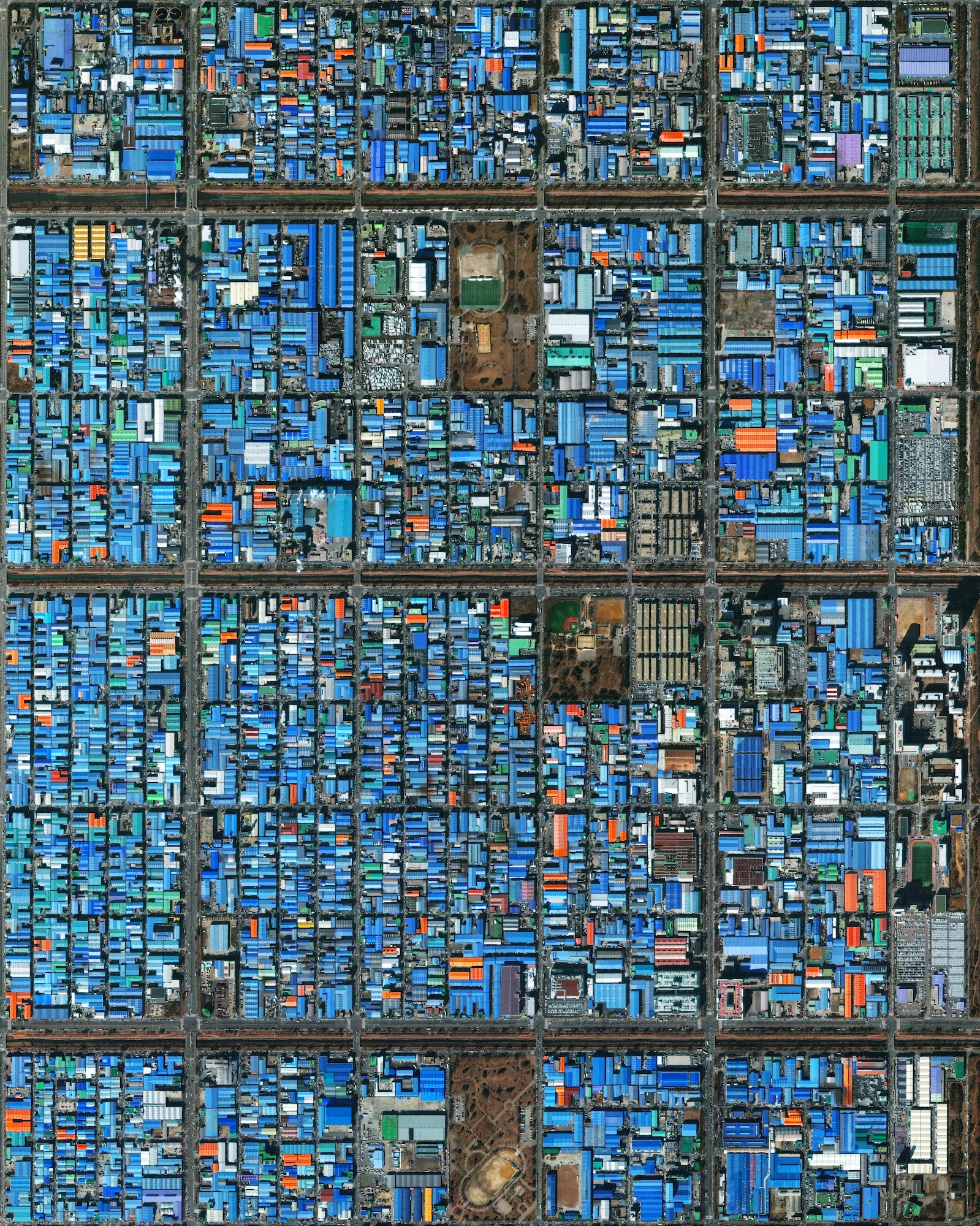 7/2/2016 Jeongwang-dong Ansan, South Korea 37.336147372°, 126.718586767° Jeongwang-dong is an industrial sector in the city of Ansan, South Korea. The Korean government intensively drove a plan to develop the modern city, particularly in this area, with an emphasis on manufacturing. The striking blue color that you see here results from the use of aluminum roofing, which is used for its low cost and longevity.