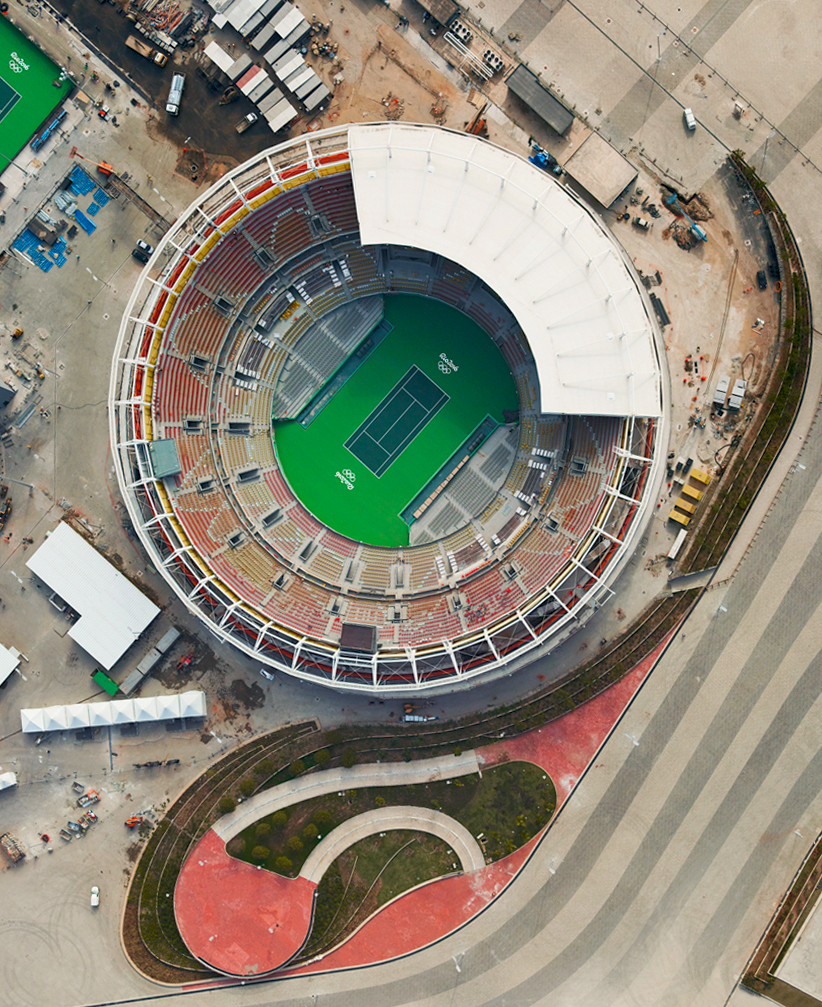 8/5/2016 Olympic Tennis Center Rio de Janiero, Brazil 22.978822°S 43.396382°W The opening ceremony of the XXXI Olympiad will take place tonight in Rio de Janeiro, Brazil. The city’s newly constructed Olympic Tennis Center and Maria Esther Bueno Court are seen in this shot from aerial photographer @gilesinfo . This particular photo is taken from Morar Olimpíadas, his new book that examines the physical transformation of Rio de Janeiro in the run up to the event. Let the games begin!