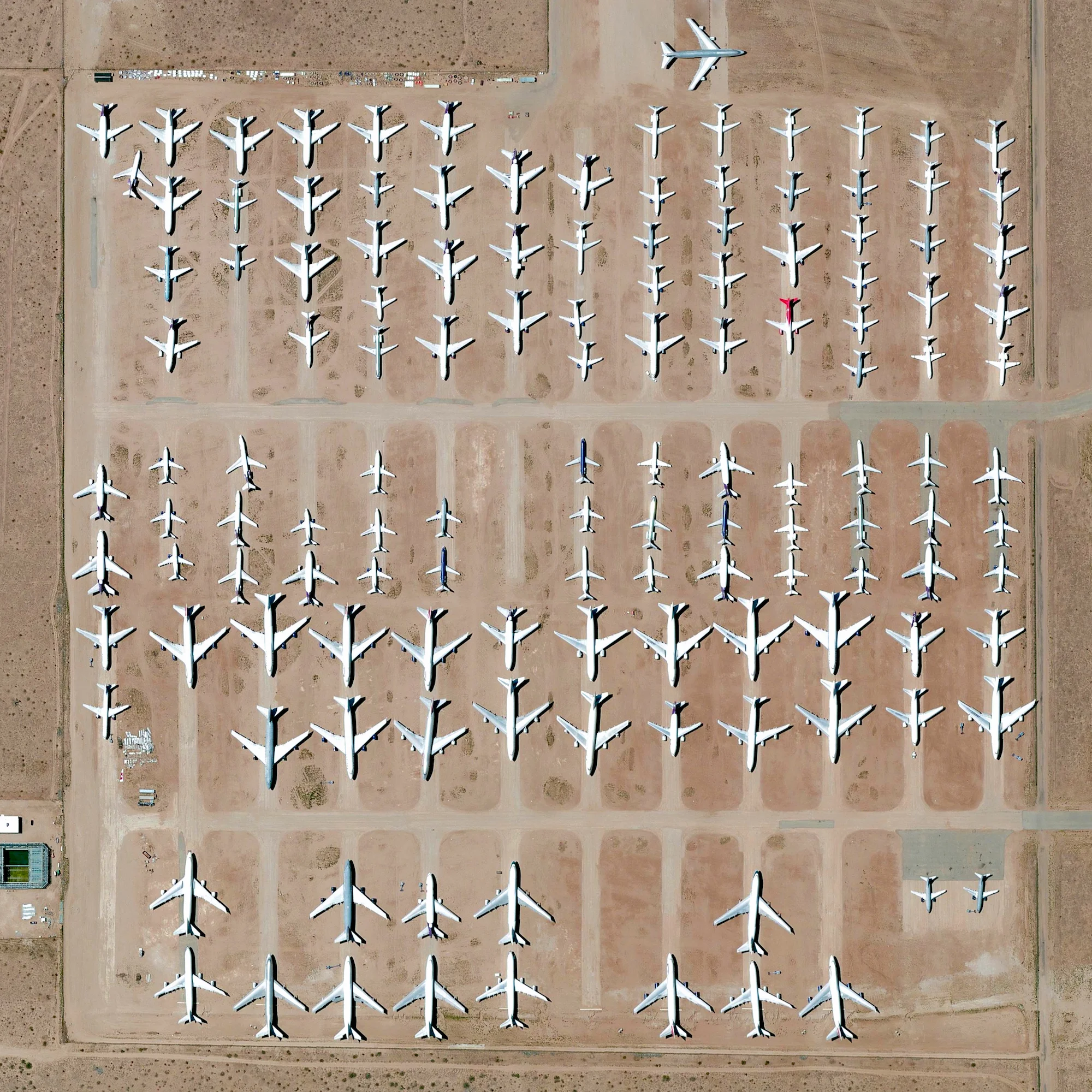 10/19/2016 Southern California Logistics Airport Victorville, California, USA 34°35′51″N 117°22′59″W Here’s one of my favorite images from the Where We Waste chapter of “Overview”. The Southern California Logistics Airport in Victorville, California contains an aircraft boneyard with more than 150 retired planes. Because the demand for jumbo jets has dropped significantly in the last two decades in favor of smaller, more affordable twin‑engine planes, many large aircrafts such as Boeing 747s have been retired. The dry conditions in Victorville – located on the edge of the Mojave Desert – limits the corrosion of metal, meaning planes can be stored here for years while they are stripped for spare parts.
