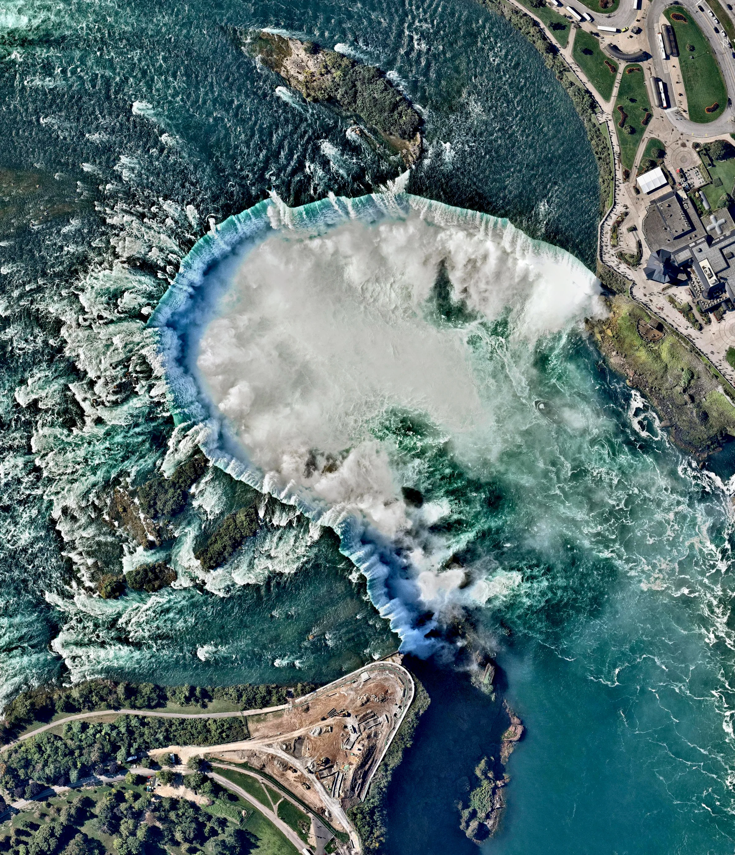 Continuing with our favorite Overviews of 2016, here is one from October of Niagara Falls — the collective name for three waterfalls that straddle the border between Ontario, Canada and the United States. Horseshoe Falls is seen here. The falls have the highest flow rate of any waterfall in the world, with a vertical drop of more than 165 feet (50 m). The Maid of the Mist, also visible here, is a boat that has carried passengers into the rapids below the falls since 1846. Source imagery: Nearmap