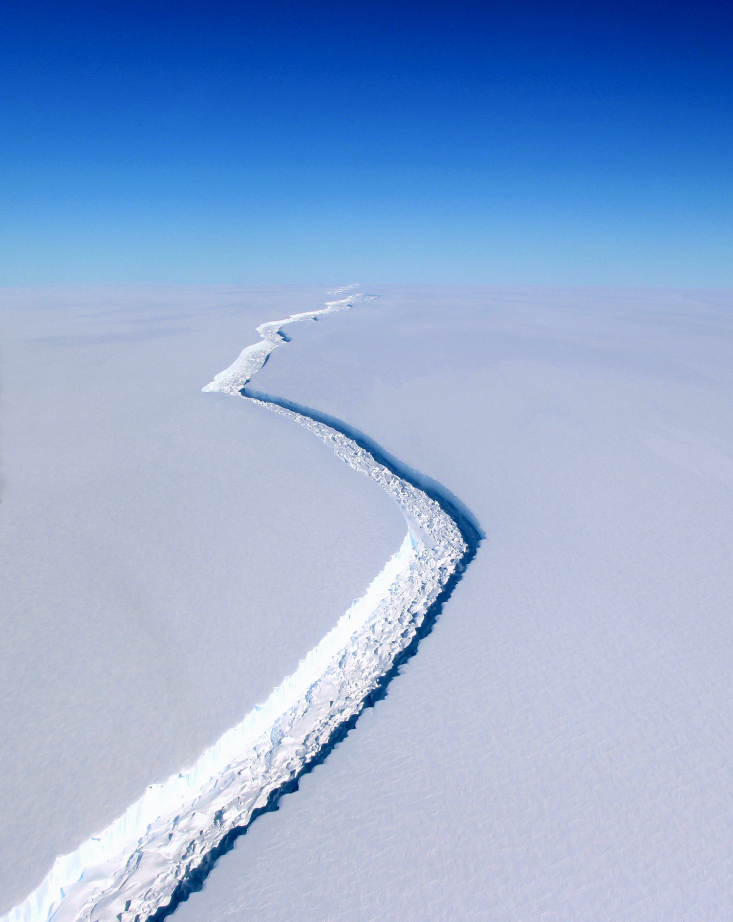 A newly formed crack in the Larsen Ice Shelf in Antarctica extends as far as the eye can see. The fracture is currently measured at 100 feet wide and over 100 miles long, growing more than 50 miles alone since 2011. If this chunk of ice breaks away, roughly 2,000 square miles will be lost - that’s roughly the size of the state of Delaware. The break is the latest example of major ice loss in the fast warming Antarctic Peninsula and could lead to a rise in global sea levels by roughly four inches (10 centimeters). Photo taken from airplane by John Sonntag for NASA