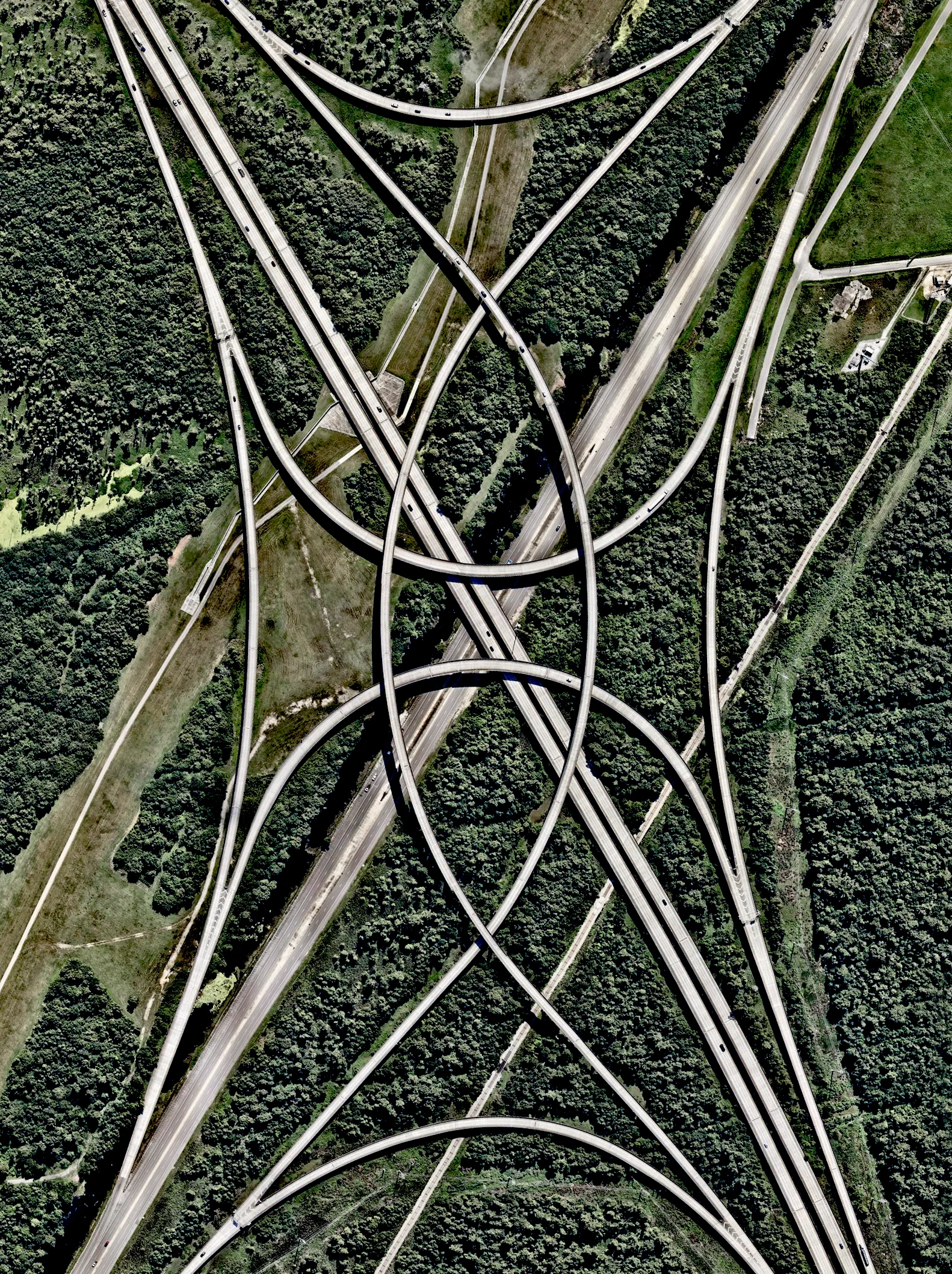 A highway interchange connects Interstate 310 and U.S Route 61 outside of New Orleans, Louisiana, USA. Because the roadways in this area were built on top of environmentally sensitive wetlands, construction platforms were mounted on top of concrete piles to minimize disruption with the terrain below. 29.975279°, -90.319193° Source imagery: Nearmap
