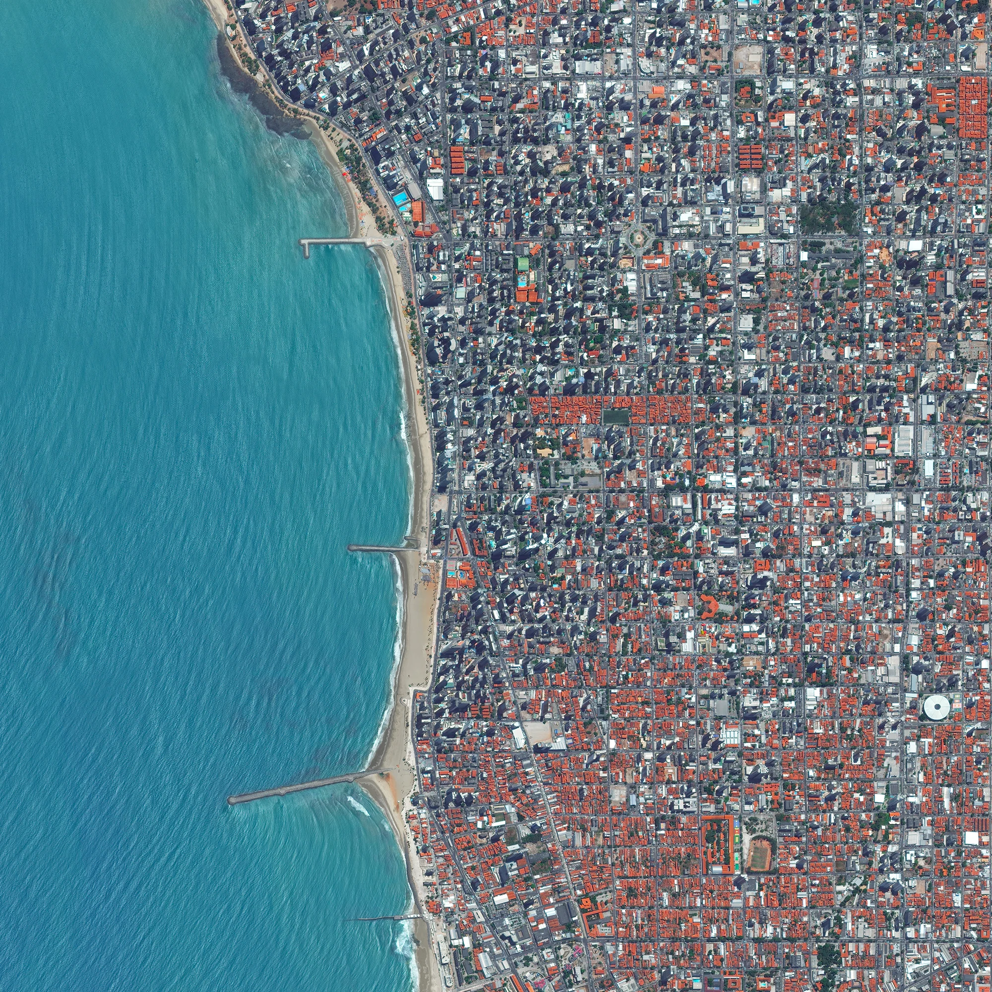 Waves rolls into the coast of Fortaleza, Brazil. Located on the Atlantic Ocean, Fortaleza has nearly 25 kilometers (16 miles) of urban beaches.The city serves the state capital of Ceará in the northeast of the country and is home to roughly 2.3 million people. 3°43′6″S 38°32′34″W