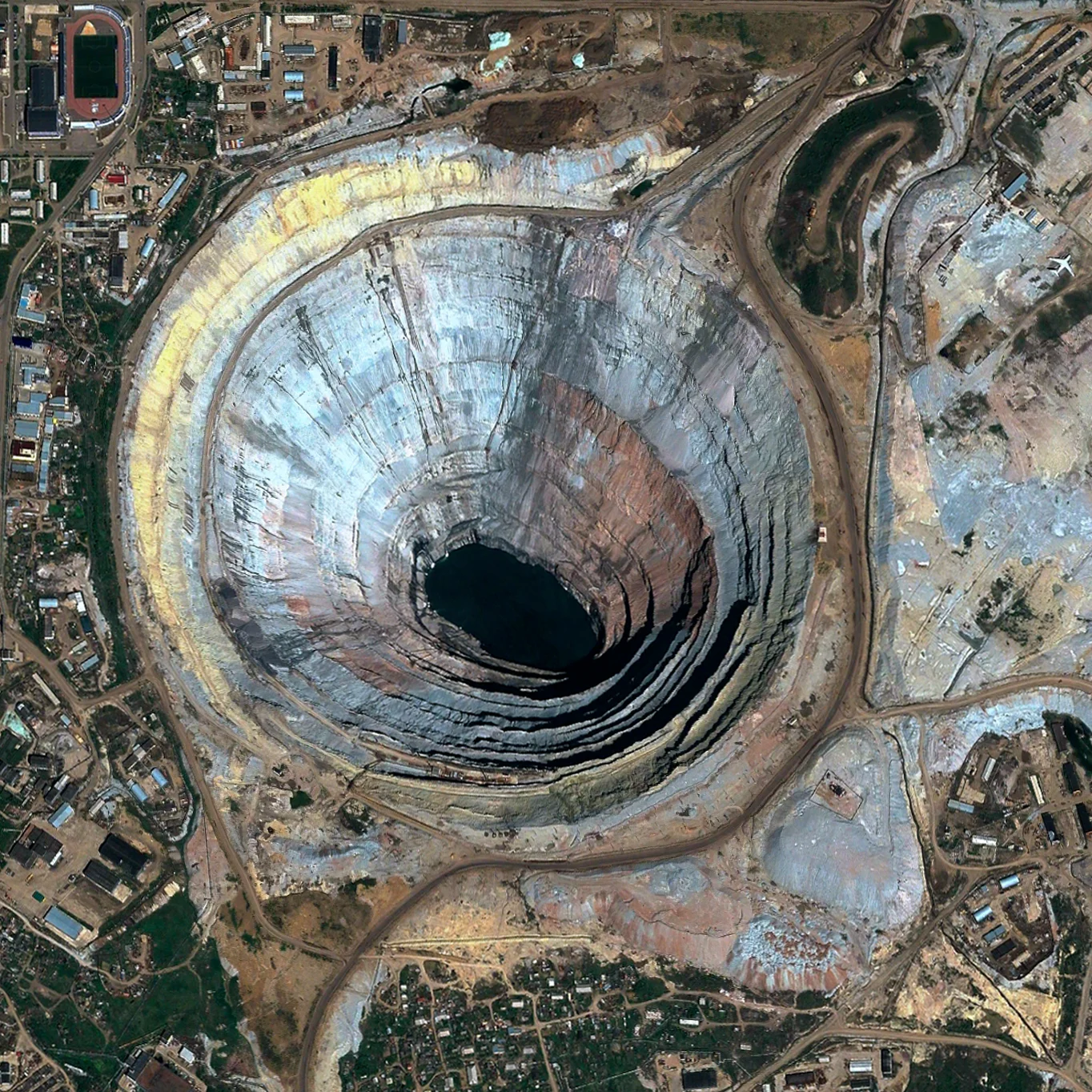 Mir Mine Mirny, Russia 62°31′45.92″N 113°59′36.74″E The Mir Mine is an inactive, open-pit diamond mine located in Mirny, Eastern Siberia, Russia. The mine is 1,722 feet (525 m) deep and has a diameter of 3,900 feet (1,200 m), making it the second largest excavated hole in the world. Active for 44 years, the mine had an output of 10 million carats of diamond per year during peak production in the 1960’s.