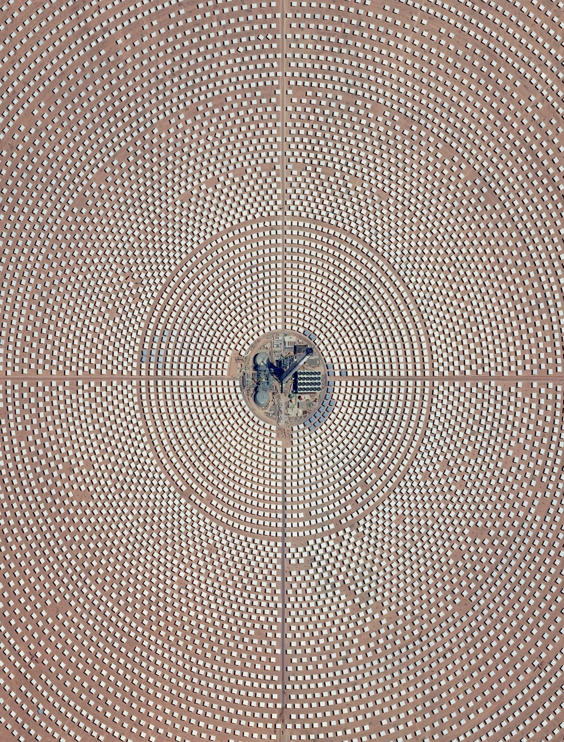 Noor 3 is one of four sections of the Ouarzazate Solar Power Station in the Drâa-Tafilalet region of Morocco. The solar concentrator contains thousands of mirrors that focus the sun’s thermal energy to heat molten salt flowing through a massive central tower. The molten salt then circulates from the tower to a storage tank, where it is used to produce steam and generate electricity. This segment of the facility is scheduled to open next year and will be the largest facility of its kind in the world once all segments are functional. 31°00′33″N 6°51′44″W