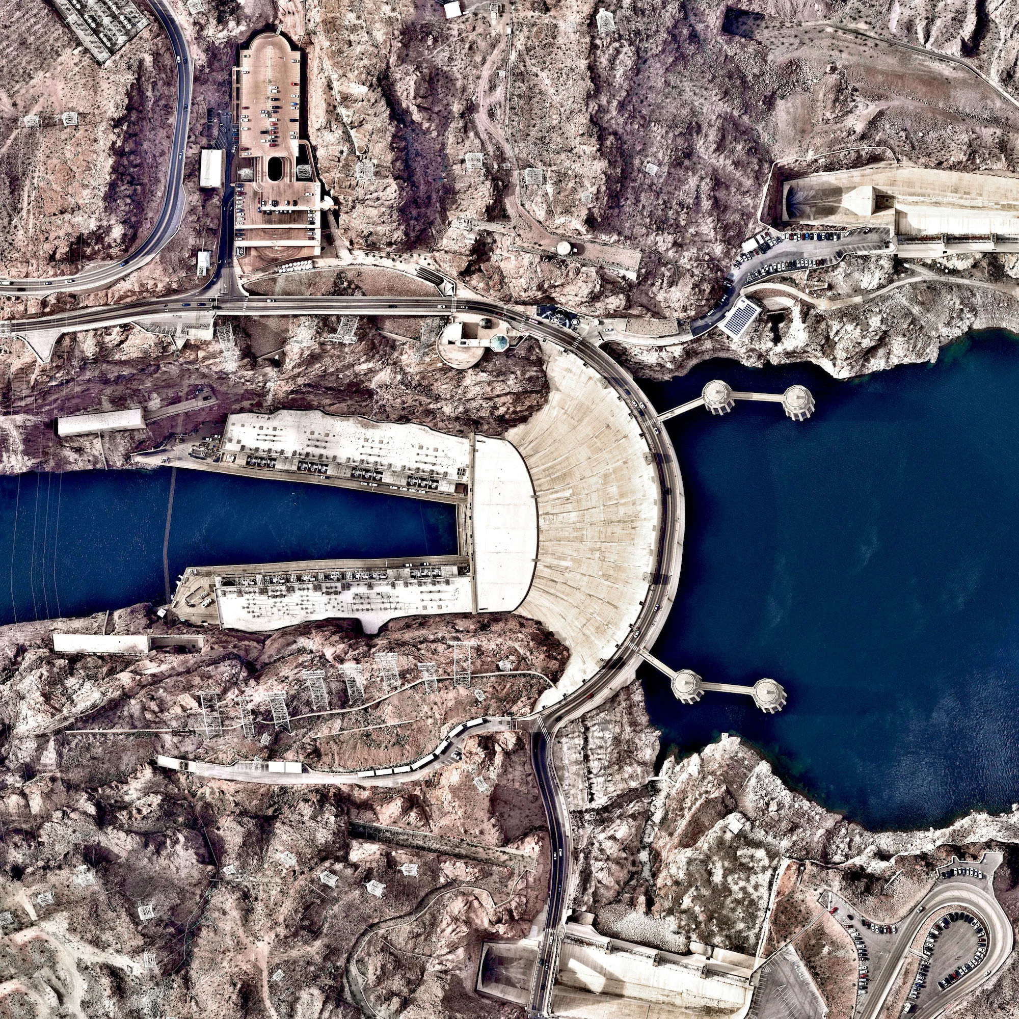Hoover Dam is a 221-meter-high (726-foot), 379-meter (1,244-foot) concrete arch-gravity dam, located on the Colorado River at the border of Arizona and Nevada, USA. Constructed between 1931 and 1936 during the Great Depression, a workforce of approximately 20,000 poured a total of 3.33 million cubic meters (4.36 million cubic yards) of concrete to complete the structure – enough to pave a two-lane highway from San Francisco to New York City. 36.015844°, – 114.738804°